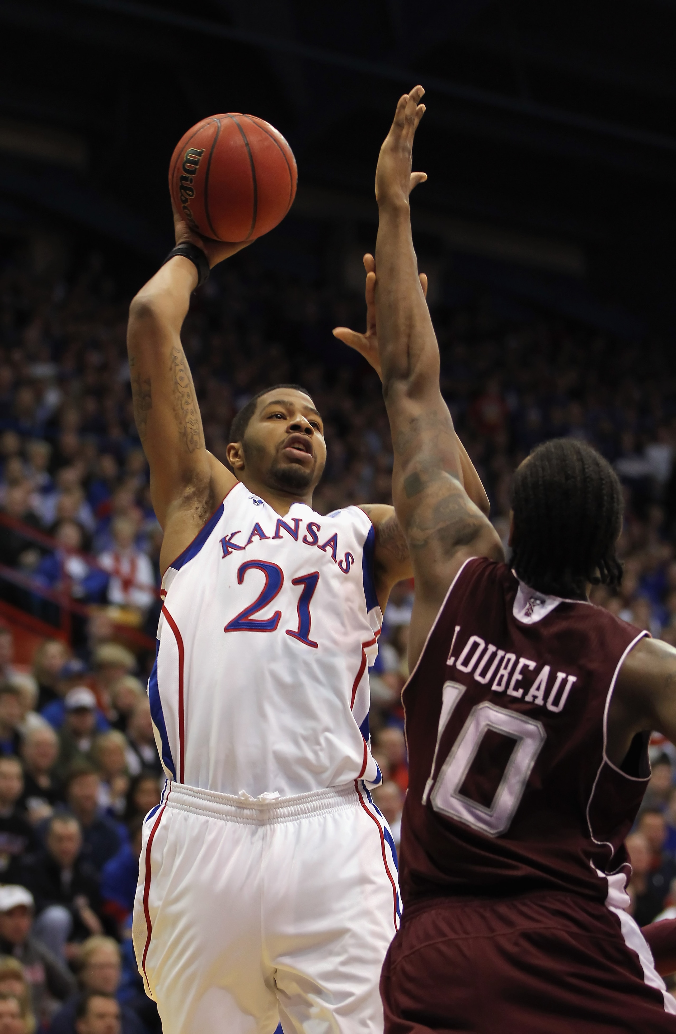 LAWRENCE, KS - MARCH 02:  Markieff Morris #21 of the Kansas Jayhawks shoots over David Loubeau #10 of the Texas A&M Aggies during the game on March 2, 2011 at Allen Fieldhouse in Lawrence, Kansas.  (Photo by Jamie Squire/Getty Images)