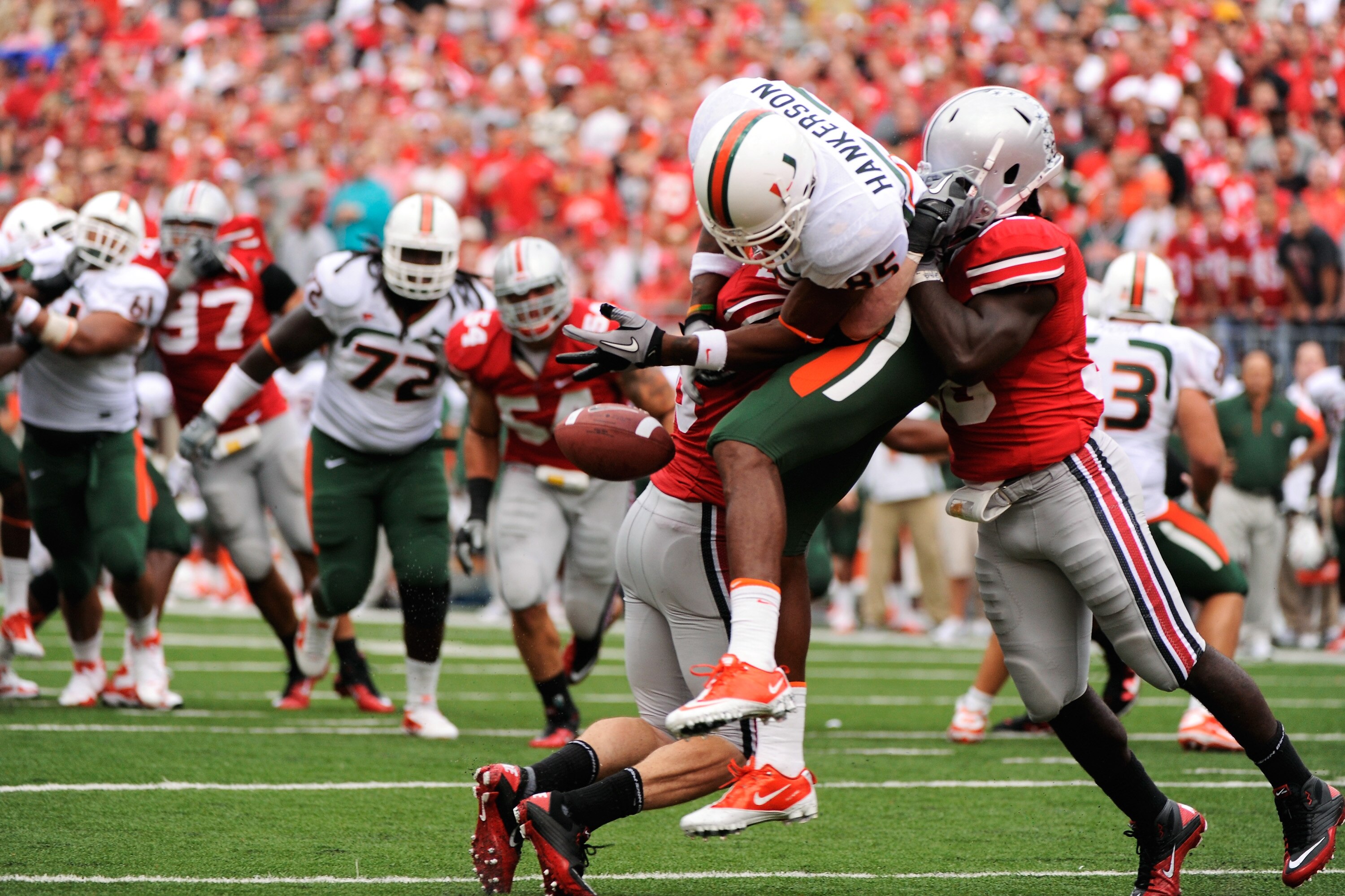 COLUMBUS, OH - SEPTEMBER 11:  Tyler Moeller #26 of the Ohio State Buckeyes and Brian Rolle #36 of the Ohio State Buckeyes sandwich Leonard Hankerson #85 of the Miami Hurricanes causing him to drop a pass on the goal line at Ohio Stadium on September 11, 2