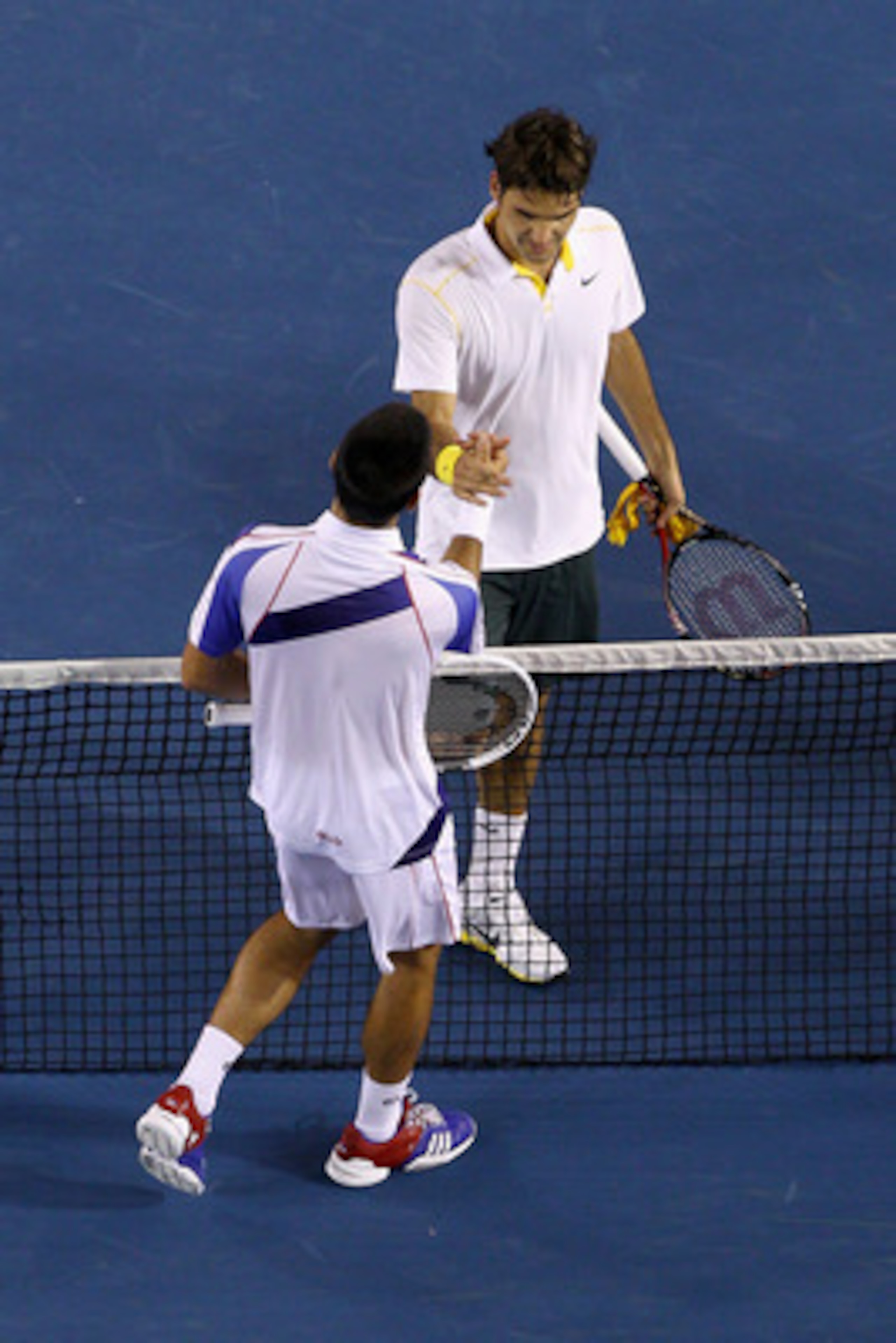 MELBOURNE, AUSTRALIA - JANUARY 27: Roger Federer of Switzerland congratulates Novak Djokovic of Serbia after their semifinal match during day eleven of the 2011 Australian Open at Melbourne Park on January 27, 2011 in Melbourne, Australia. (Photo by Qui MELBOURNE, AUSTRALIA - JANUARY 27: Roger Federer of Switzerland congratulates Novak Djokovic of Serbia after their semifinal match during day eleven of the 2011 Australian Open at Melbourne Park on January 27, 2011 in Melbourne, Australia. (Photo by Qui