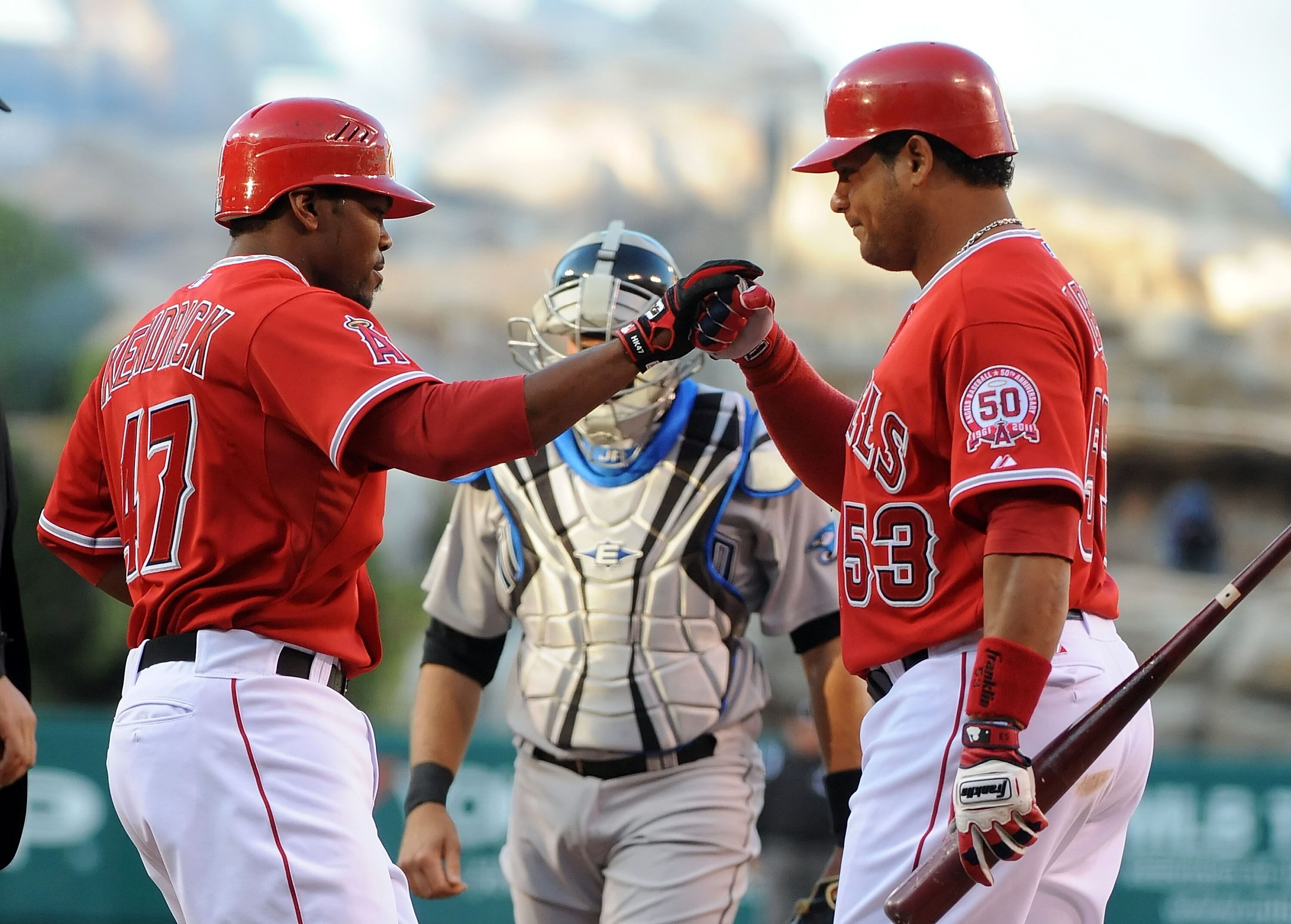 ANAHEIM, CA - APRIL 09:  (L-R)Howie Kendrick #47 celebrates with teammate Bobby Abreu #53 of the Los Angeles Angels of Anaheim after scoring in the first inning against the Toronto Blue Jays at Angel Stadium of Anaheim on April 9, 2011 in Anaheim, Califor