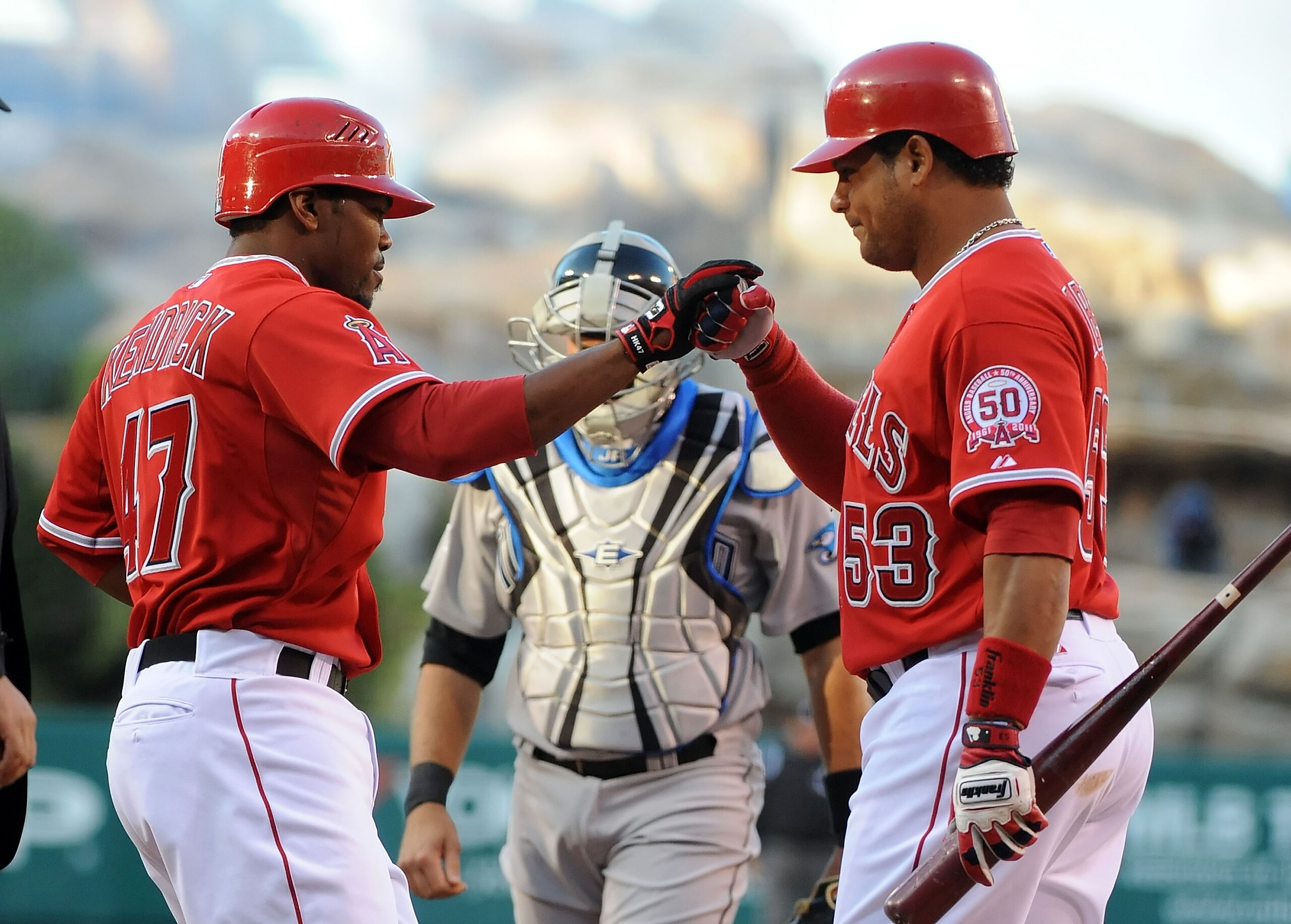 ANAHEIM, CA - APRIL 09:  (L-R)Howie Kendrick #47 celebrates with teammate Bobby Abreu #53 of the Los Angeles Angels of Anaheim after scoring in the first inning against the Toronto Blue Jays at Angel Stadium of Anaheim on April 9, 2011 in Anaheim, Califor