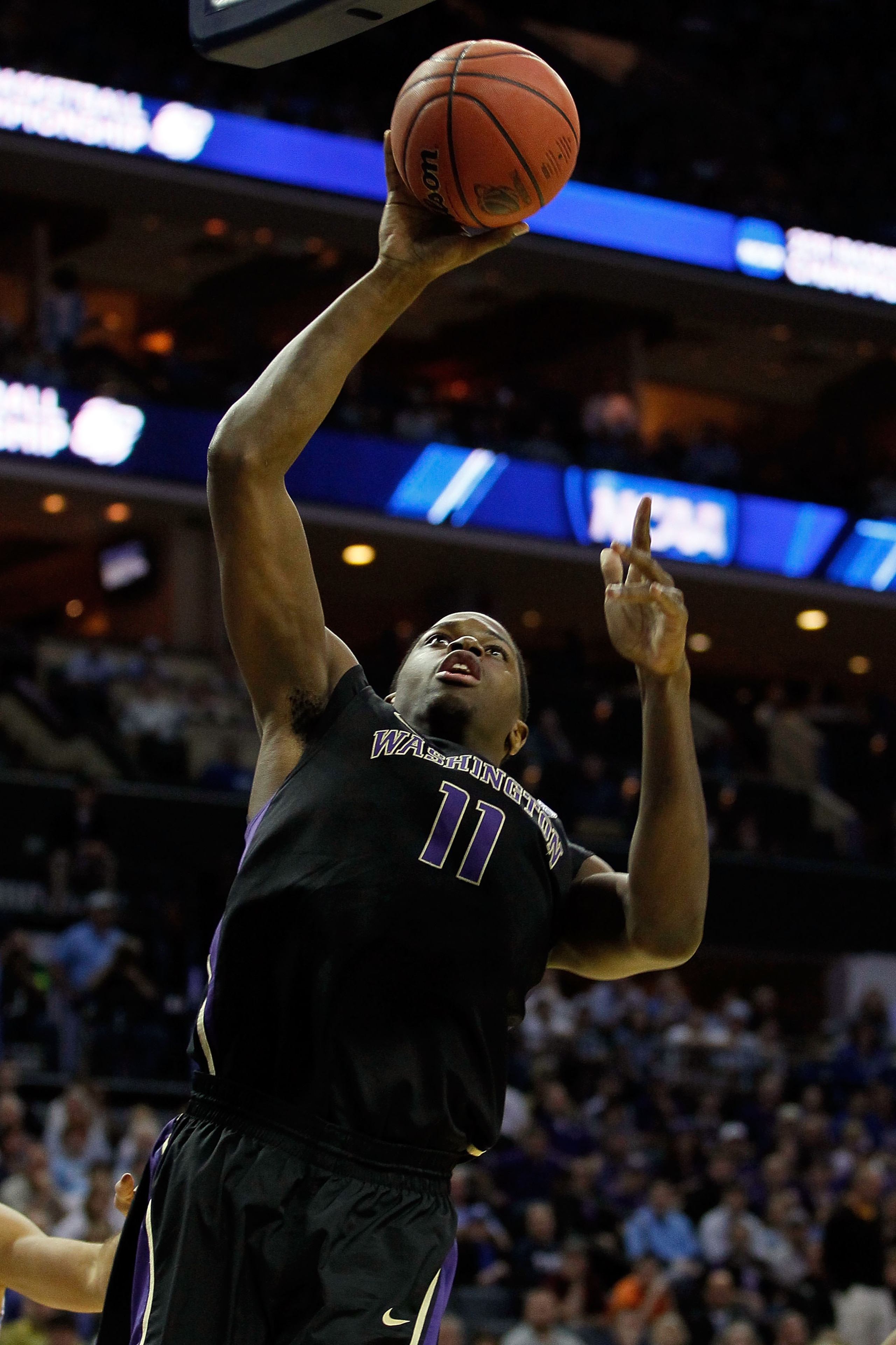 CHARLOTTE, NC - MARCH 20:  Matthew Bryan-Amaning #11 of the Washington Huskies goes up for a layup in the first half while taking on the North Carolina Tar Heels during the third round of the 2011 NCAA men's basketball tournament at Time Warner Cable Aren