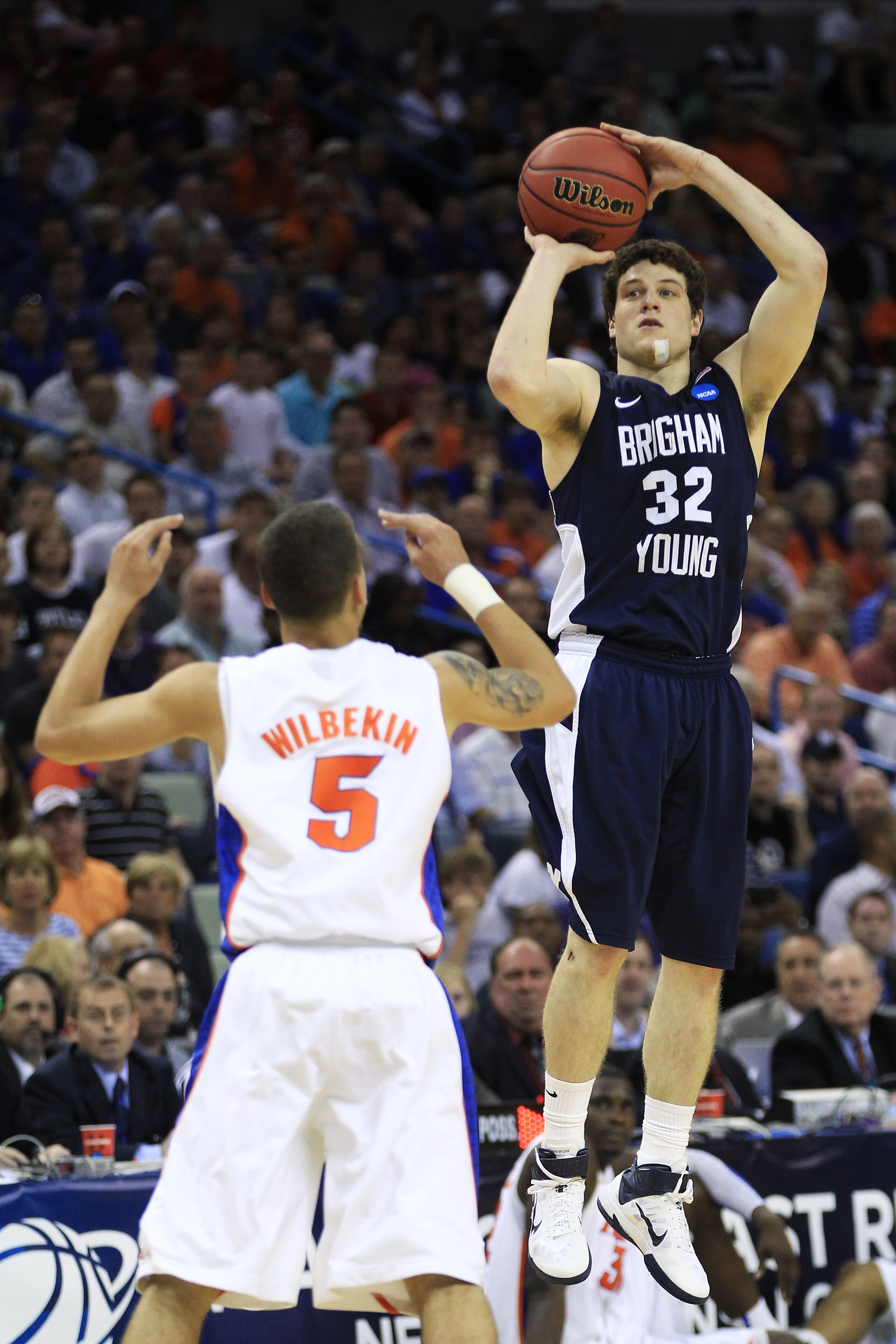 NEW ORLEANS, LA - MARCH 24: Jimmer Fredette #32 of the Brigham Young Cougars shoots over Scottie Wilbekin #5 of the Florida Gators in the second half during the Southeast regional of the 2011 NCAA men's basketball tournament at New Orleans Arena on March NEW ORLEANS, LA - MARCH 24: Jimmer Fredette #32 of the Brigham Young Cougars shoots over Scottie Wilbekin #5 of the Florida Gators in the second half during the Southeast regional of the 2011 NCAA men's basketball tournament at New Orleans Arena on March