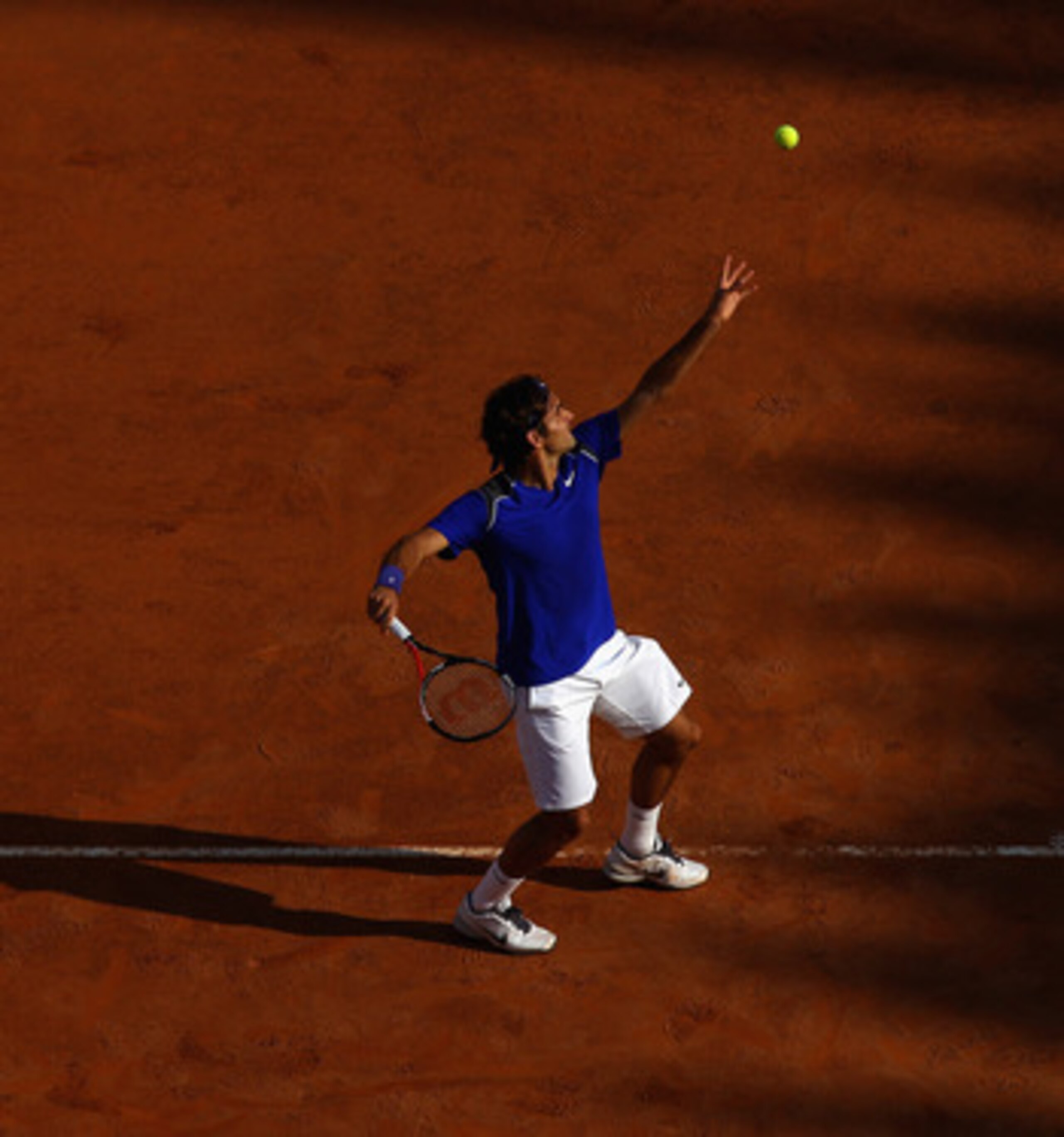 ROME, ITALY - MAY 12: Roger Federer of Switzerland serves during his third round match against Richard Gasquet of France during day five of the Internazionali BNL d'Italia at the Foro Italico Tennis Centre on May 12, 2011 in Rome, Italy. (Photo by Alex ROME, ITALY - MAY 12: Roger Federer of Switzerland serves during his third round match against Richard Gasquet of France during day five of the Internazionali BNL d'Italia at the Foro Italico Tennis Centre on May 12, 2011 in Rome, Italy. (Photo by Alex