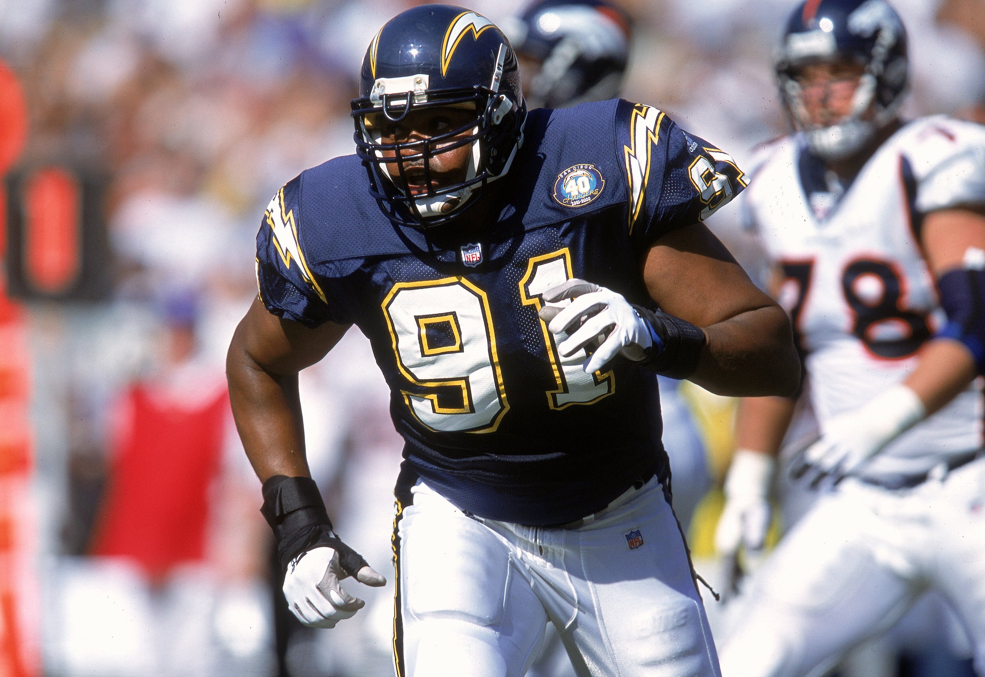 8 Oct 2000:  Neil Smith #91 of the San Diego Chargers rushes on the field during a game against the Denver Broncos at the Qualcomm Stadium in San Diego, California. The Broncos defeated the Chargers 21-7.Mandatory Credit: Stephen Dunn  /Allsport