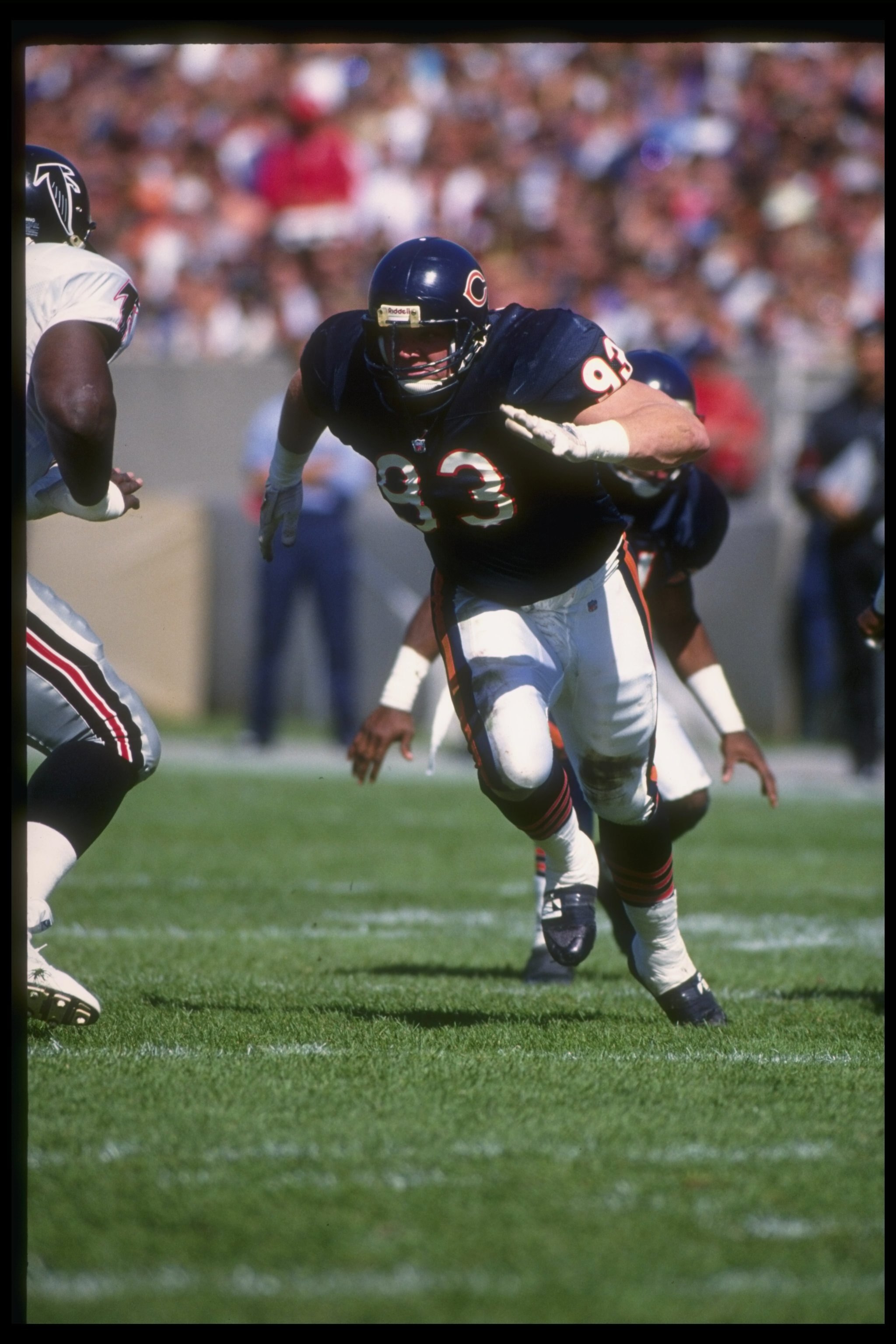 27 Sep 1992: Defensive lineman Trace Armstrong of the Chicago Bears (right) rushes the Atlanta Falcons line during a game at Soldier Field in Chicago, Illinois. The Bears won the game, 41-31.