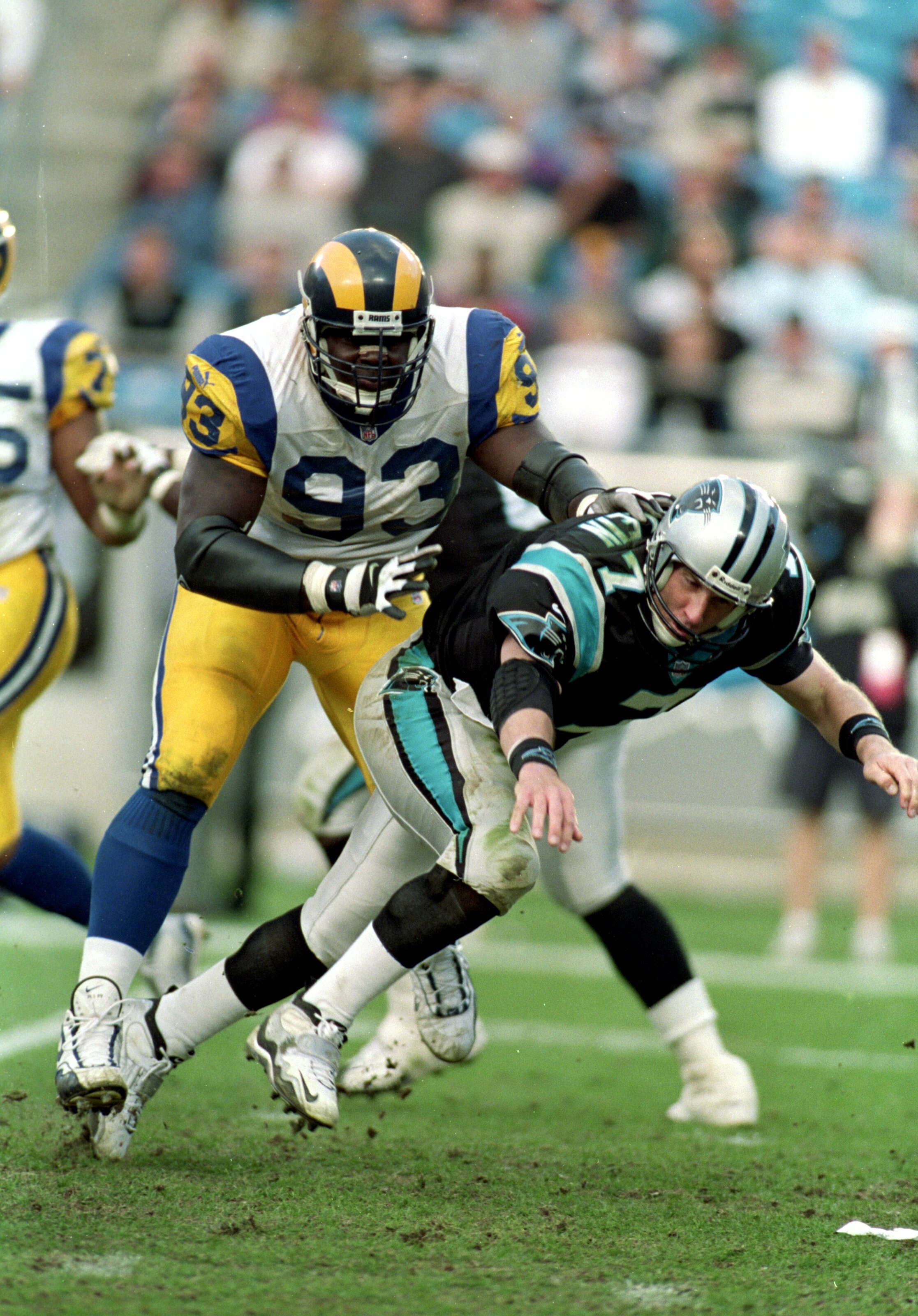 5 Dec 1999: Kevin Carter #93  of the St.Louis Rams tackles Steve Beuerlein #7 of the Carolina Panthers at the Ericsson Stadium in Charlotte, North Carolina. The Rams defeated the Panthers 34-21. Mandatory Credit: Al Bello  /Allsport