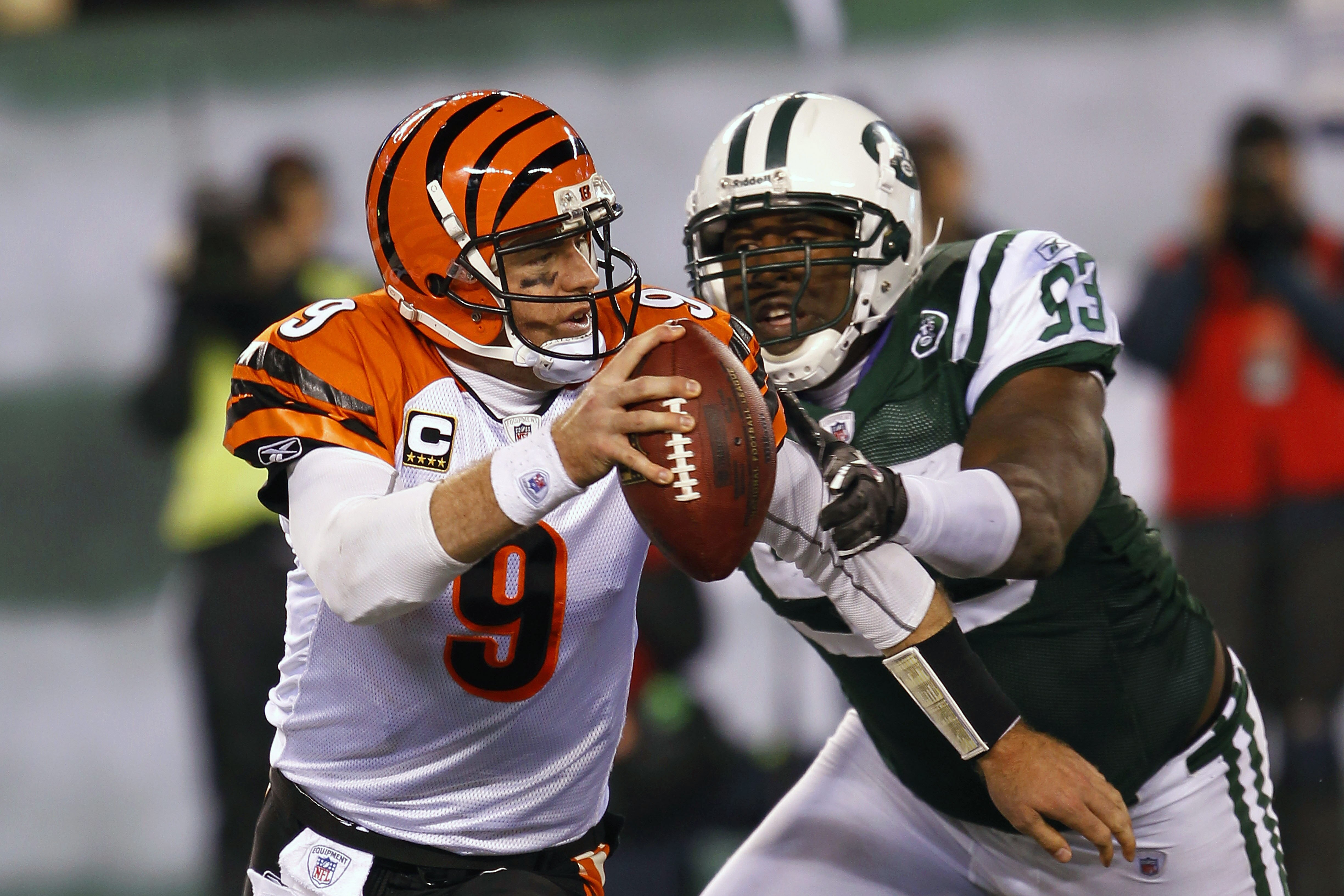 EAST RUTHERFORD, NJ - NOVEMBER 25:  Quarterback Carson Palmer #9 of the Cincinnati Bengals is tackled for a safety by Trevor Pryce #93 of the New York Jets at New Meadowlands Stadium on November 25, 2010 in East Rutherford, New Jersey. The Jets defeated t