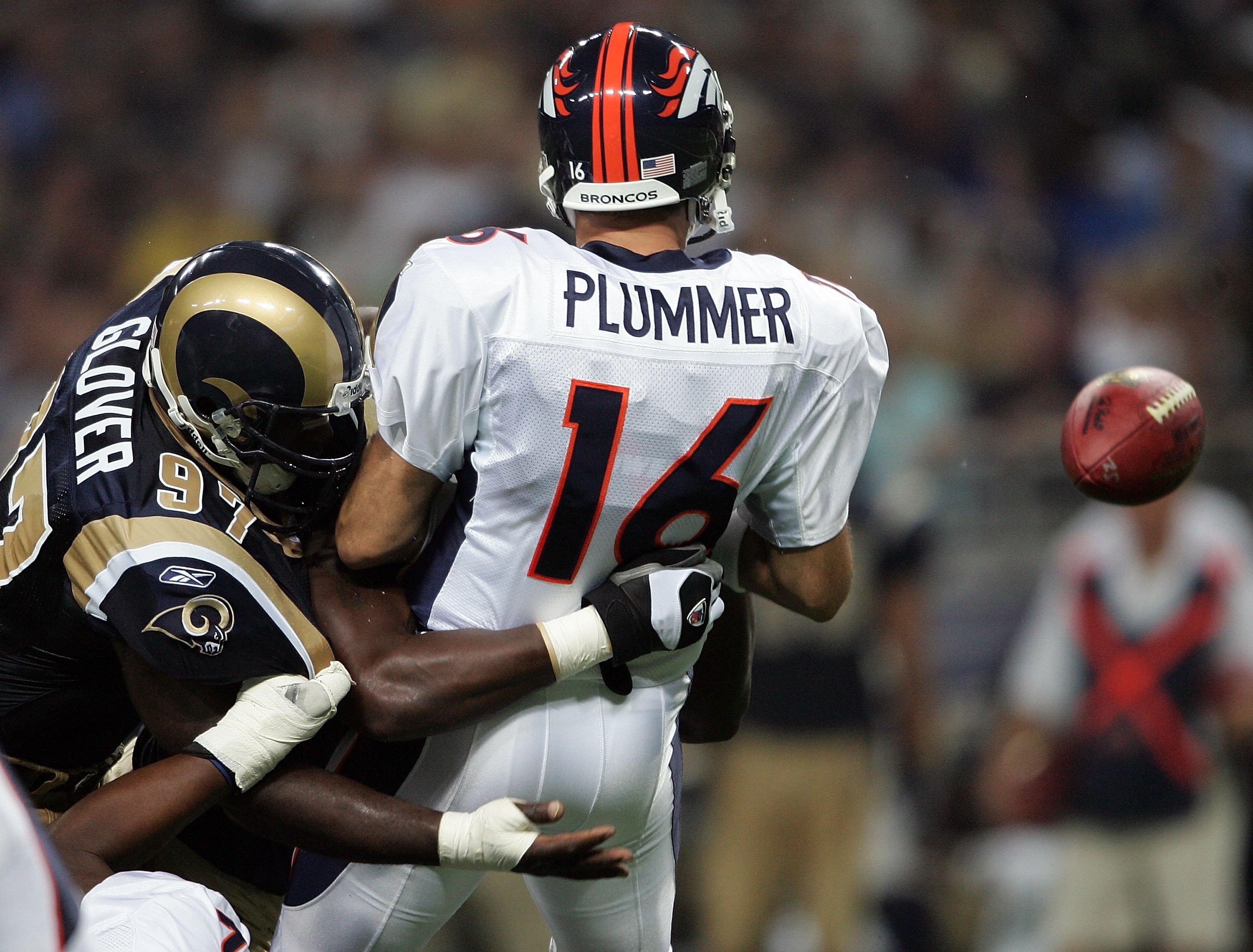 ST. LOUIS - SEPTEMBER 10:  Jake Plummer #16 of the Denver Broncos fumbles the ball as he is hit by Leonard Little #91 and La'Roi Glover #97 of the St. Louis Rams on September 10, 2006 at the Edward Jones Dome in St. Louis, Missouri. The Rams recovered the