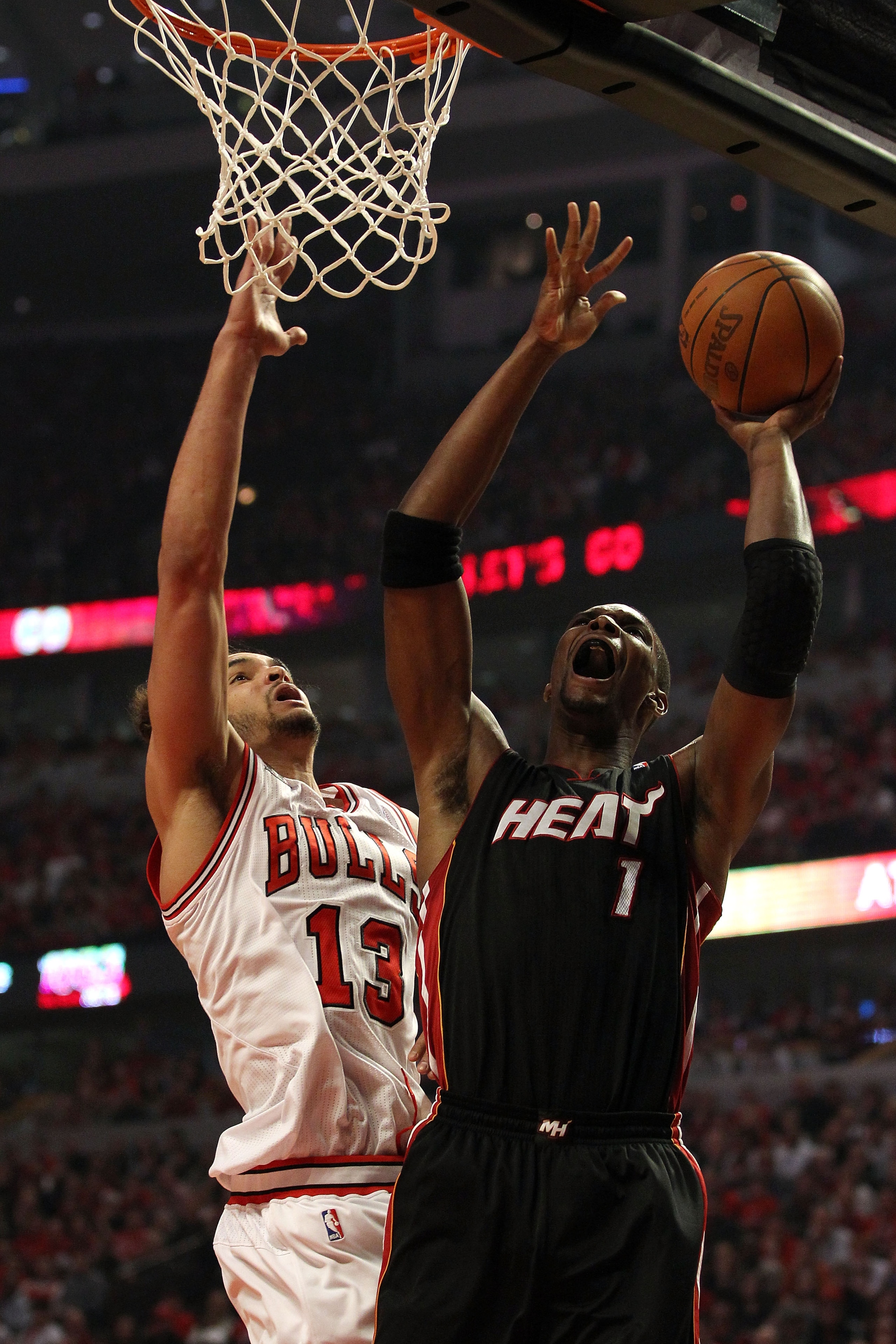CHICAGO, IL - MAY 15:  Chris Bosh #1 of the Miami Heat attempts a shot in the first quarter against Joakim Noah #13 of the Chicago Bulls in Game One of the Eastern Conference Finals during the 2011 NBA Playoffs on May 15, 2011 at the United Center in Chic