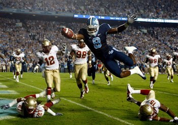 CHAPEL HILL, NC - OCTOBER 22:  Greg Little #8 of the North Carolina Tar Heels dives past Florida State Seminole defenders for a first quarter touchdown at Kenan Stadium on October 22, 2009 in Chapel Hill, North Carolina.  (Photo by Scott Halleran/Getty Im