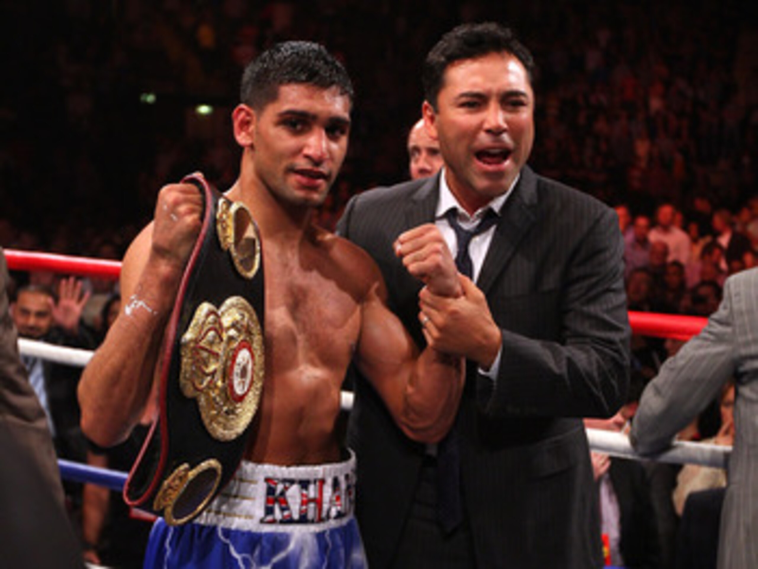 MANCHESTER, ENGLAND - APRIL 16: Amir Khan celebrates after with Oscar de la Hoya after victory over Paul McCloskey in the WBA Light-Welterweight Championship fight between Amir Khan and Paul McCloskey at MEN Arena on April 16, 2011 in Manchester, England MANCHESTER, ENGLAND - APRIL 16: Amir Khan celebrates after with Oscar de la Hoya after victory over Paul McCloskey in the WBA Light-Welterweight Championship fight between Amir Khan and Paul McCloskey at MEN Arena on April 16, 2011 in Manchester, England