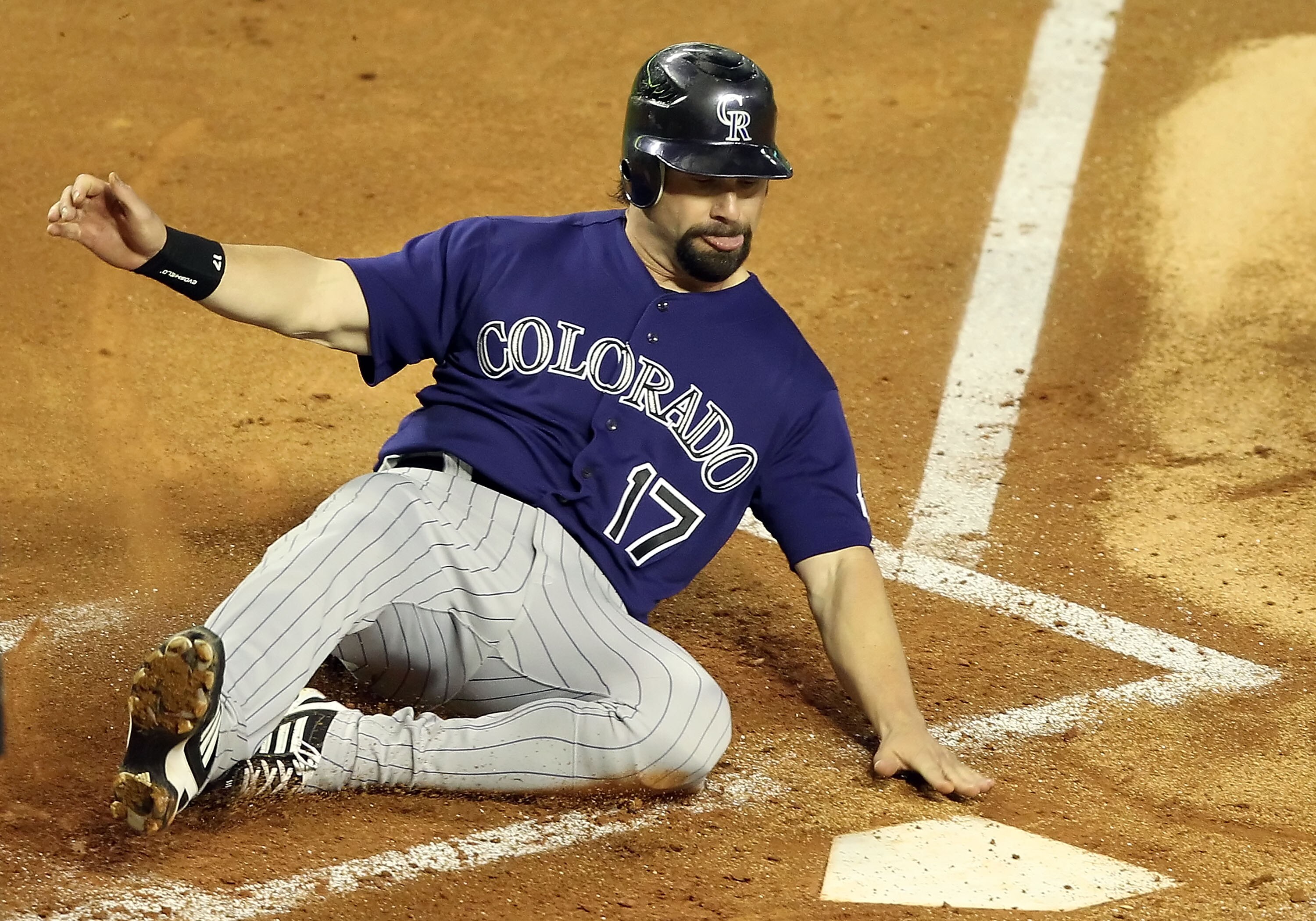 PHOENIX, AZ - MAY 04:  Todd Helton #17 of the Colorado Rockies slides in to score a fourth inning run against the Arizona Diamondbacks during the Major League Baseball game at Chase Field on May 4, 2011 in Phoenix, Arizona.  (Photo by Christian Petersen/G
