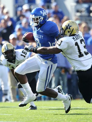 LEXINGTON, KY - NOVEMBER 13:  Chris Matthews #8 of the Kentucky Wildcats runs with the ball while defended by Chris Marve #13 of the Vanderbilt Commodores at Commonwealth Stadium on November 13, 2010 in Lexington, Kentucky.  (Photo by Andy Lyons/Getty Ima