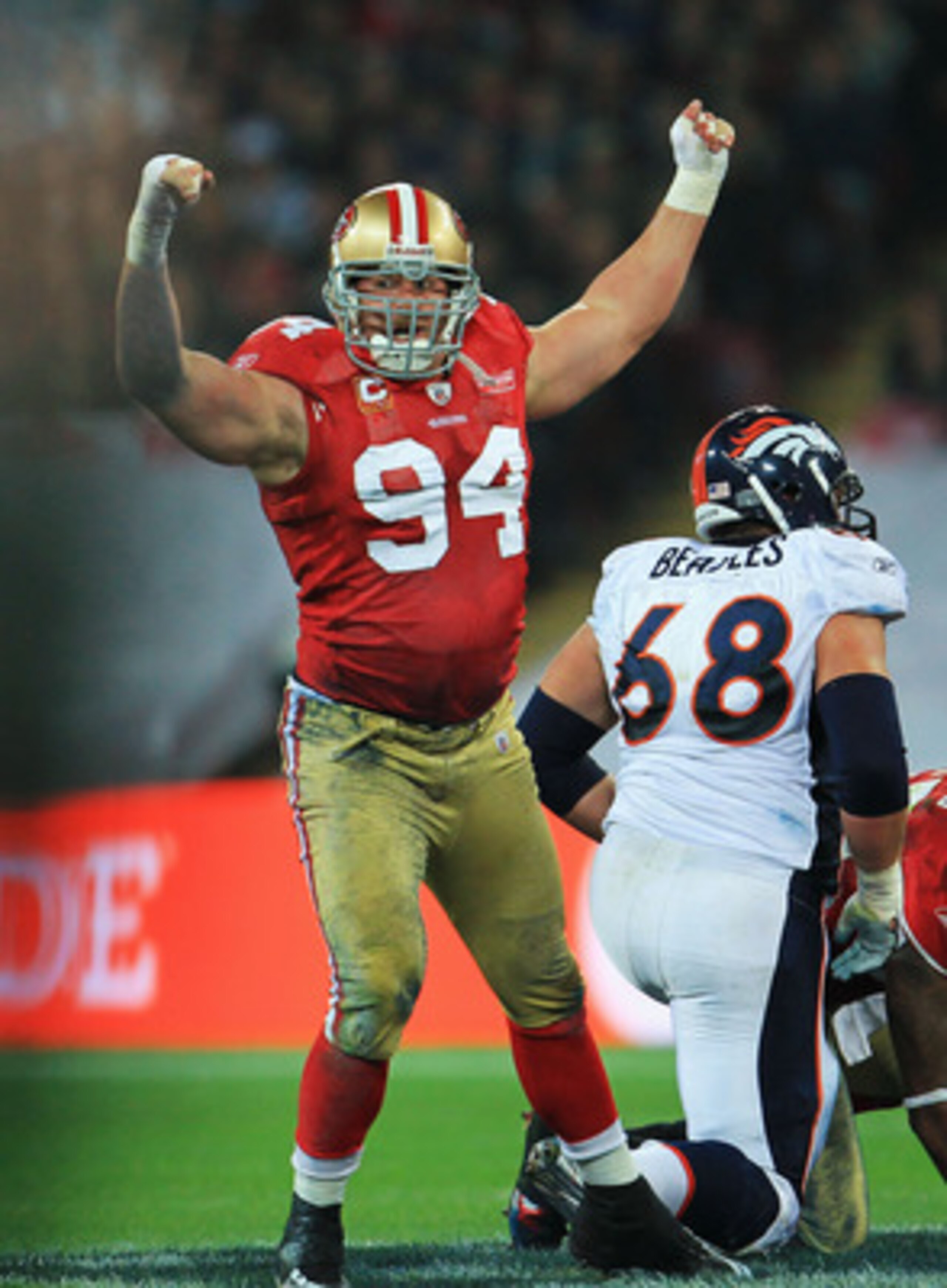 LONDON, ENGLAND - OCTOBER 31:  Justin Smith #94 of San Francisco 49ers celebrates sacking Kyle Orton the Denver Broncos Quarterback during the NFL International Series match between Denver Broncos and San Francisco 49ers at Wembley Stadium on October 31, 