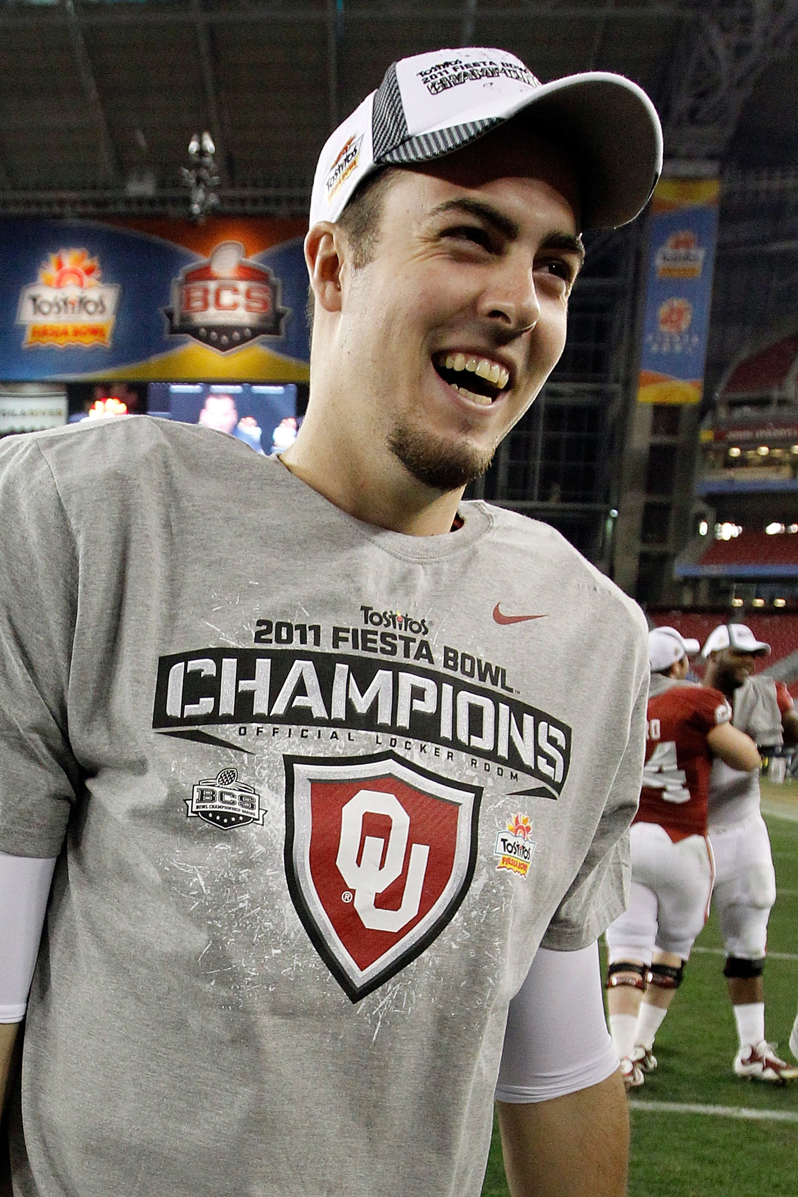 GLENDALE, AZ - JANUARY 01:  Quarterback Landry Jones #12 of the Oklahoma Sooners and offensive MVP celebrates the Sooners 48-20 victory against the Connecticut Huskies during the Tostitos Fiesta Bowl at the Universtity of Phoenix Stadium on January 1, 201