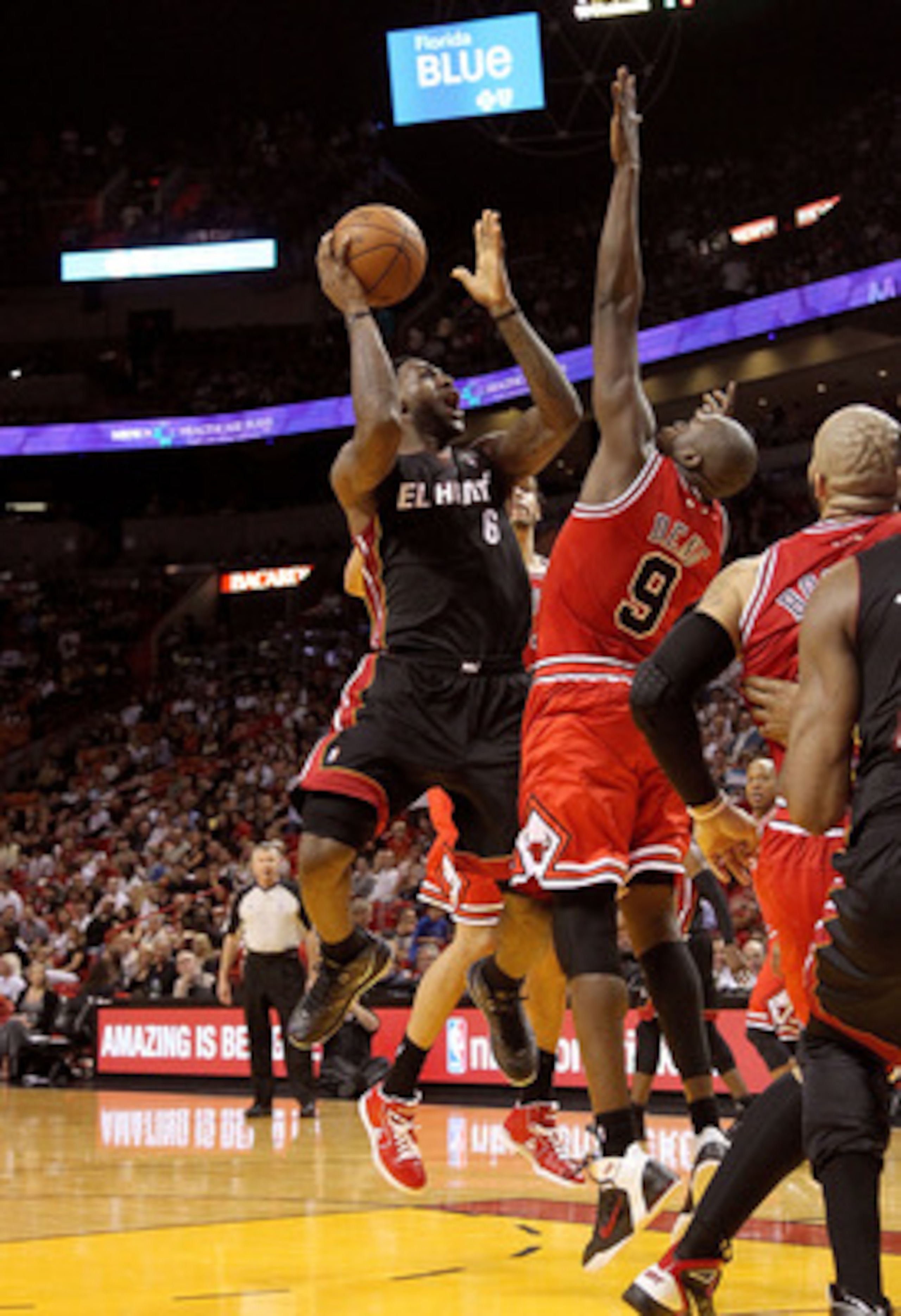 MIAMI, FL - MARCH 06:  LeBron James #6 of the Miami Heat shoots over Luol Deng #9 of the Chicago Bulls during a game at American Airlines Arena on March 6, 2011 in Miami, Florida. NOTE TO USER: User expressly acknowledges and agrees that, by downloading a