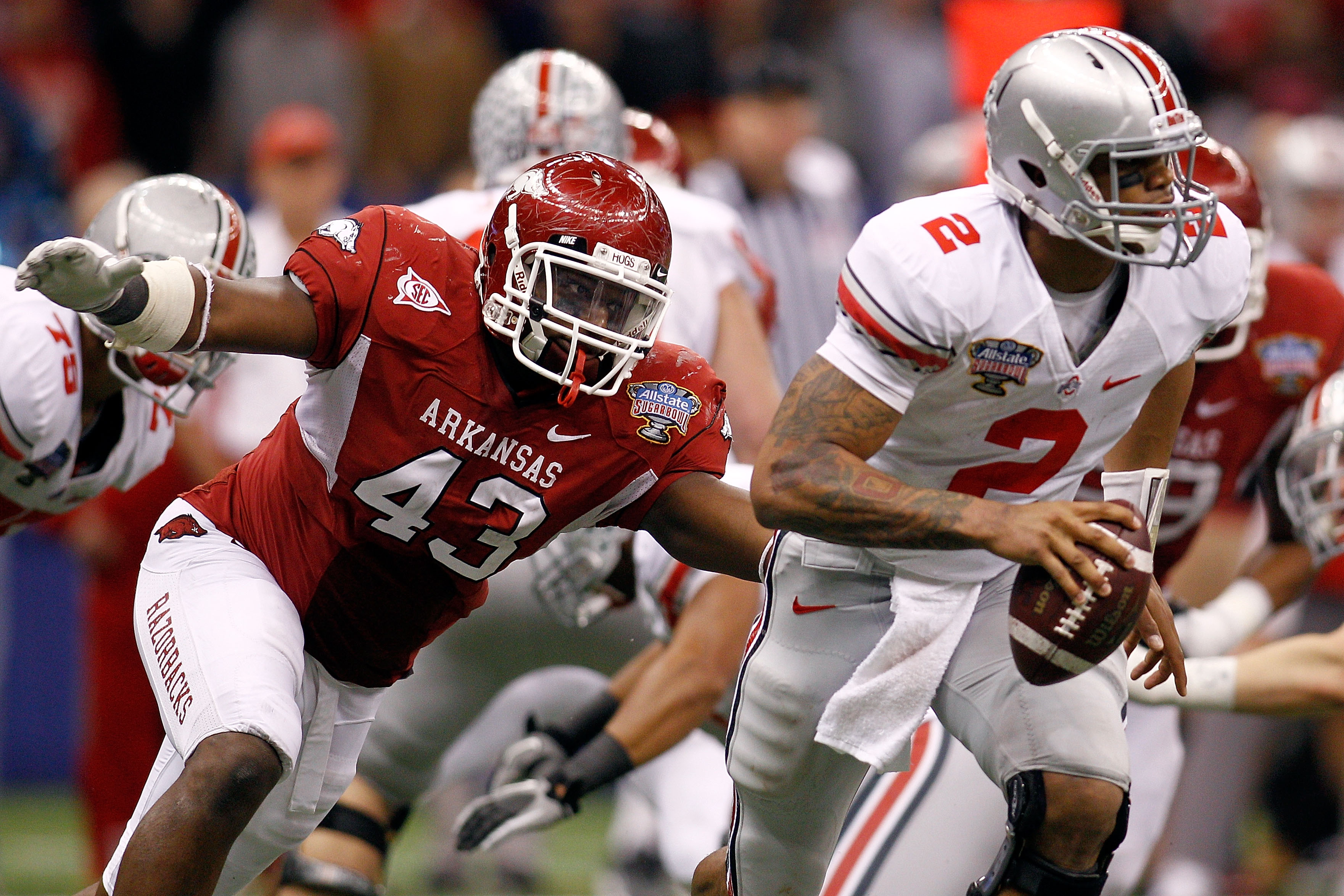 NEW ORLEANS, LA - JANUARY 04:  Quarterback Terrelle Pryor #2 of the Ohio State Buckeyes avoids a rush from Tenarius Wright #43 of the Arkansas Razorbacks in the fourth quarter during the Allstate Sugar Bowl at the Louisiana Superdome on January 4, 2011 in