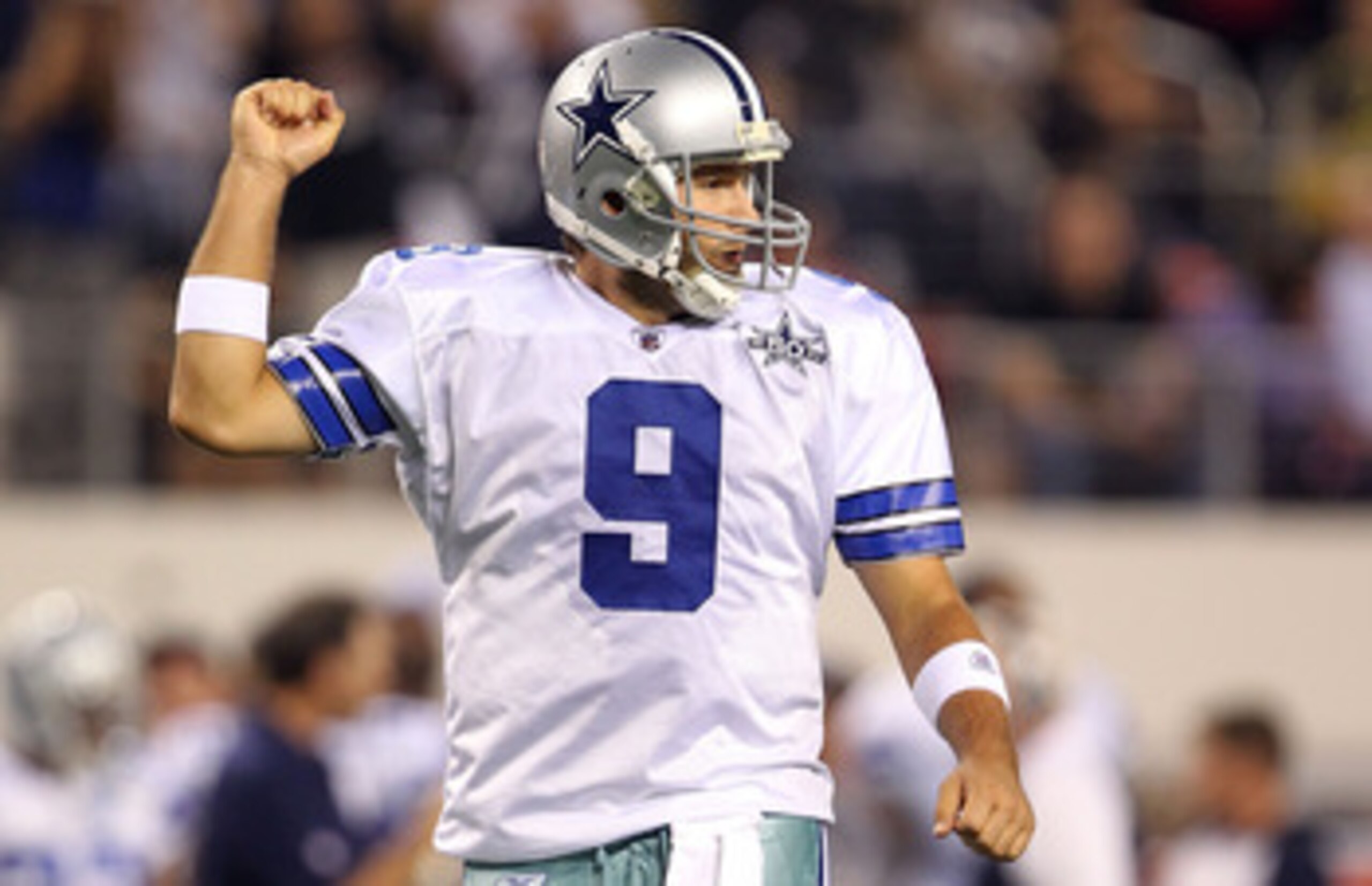 ARLINGTON, TX - OCTOBER 25:  Quarterback Tony Romo #9 of the Dallas Cowboys celebrates a touchdown by Jason Witten against the New York Giants in the first quarter at Cowboys Stadium on October 25, 2010 in Arlington, Texas.  (Photo by Ronald Martinez/Gett