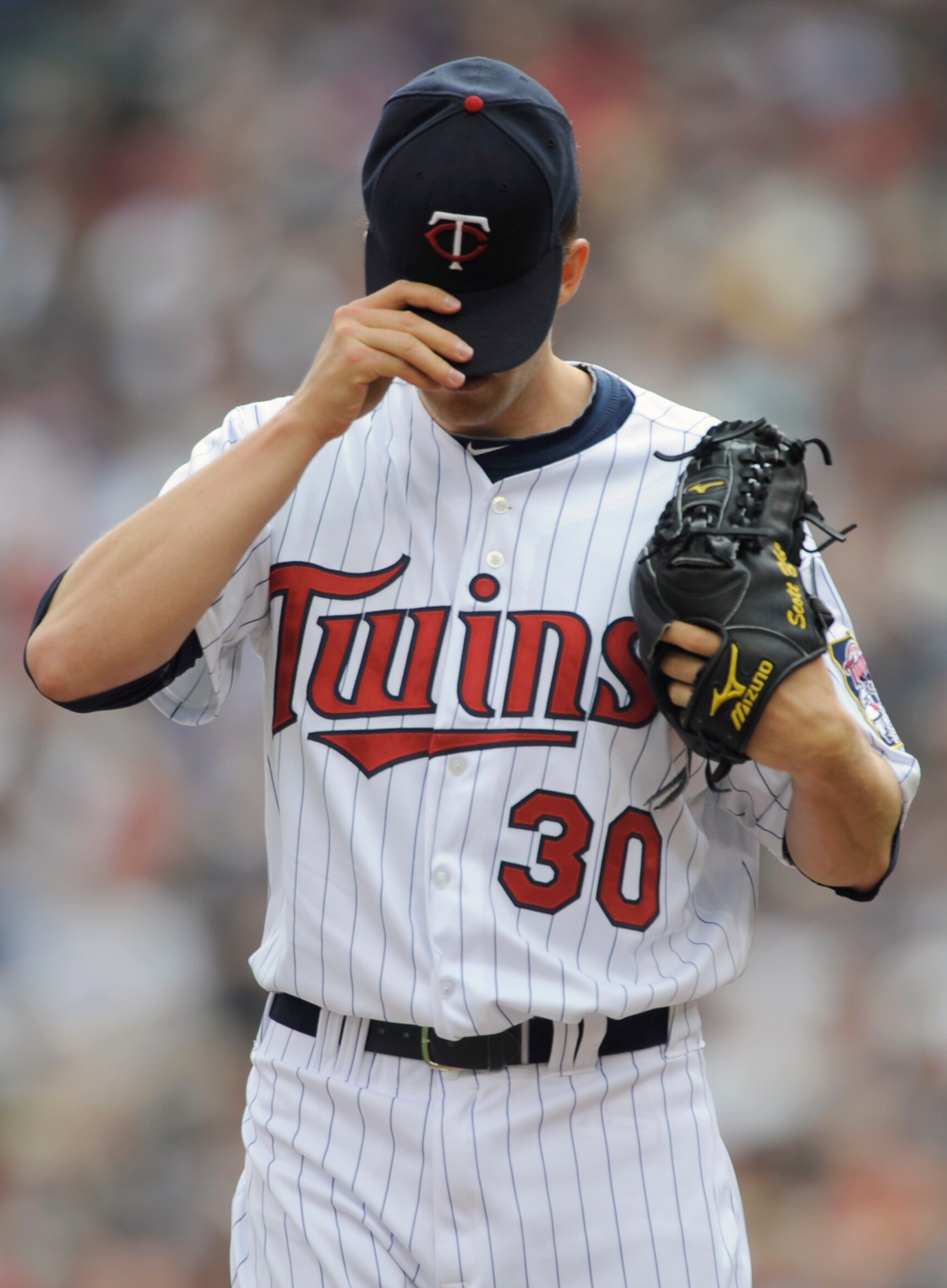 MINNEAPOLIS, MN - APRIL 10: Starting pitcher Scott Baker #30 of the Minnesota Twins adjusts his hat during the first inning of their game against the Minnesota Twins on April 10, 2011 at Target Field in Minneapolis, Minnesota. (Photo by Hannah Foslien/Get