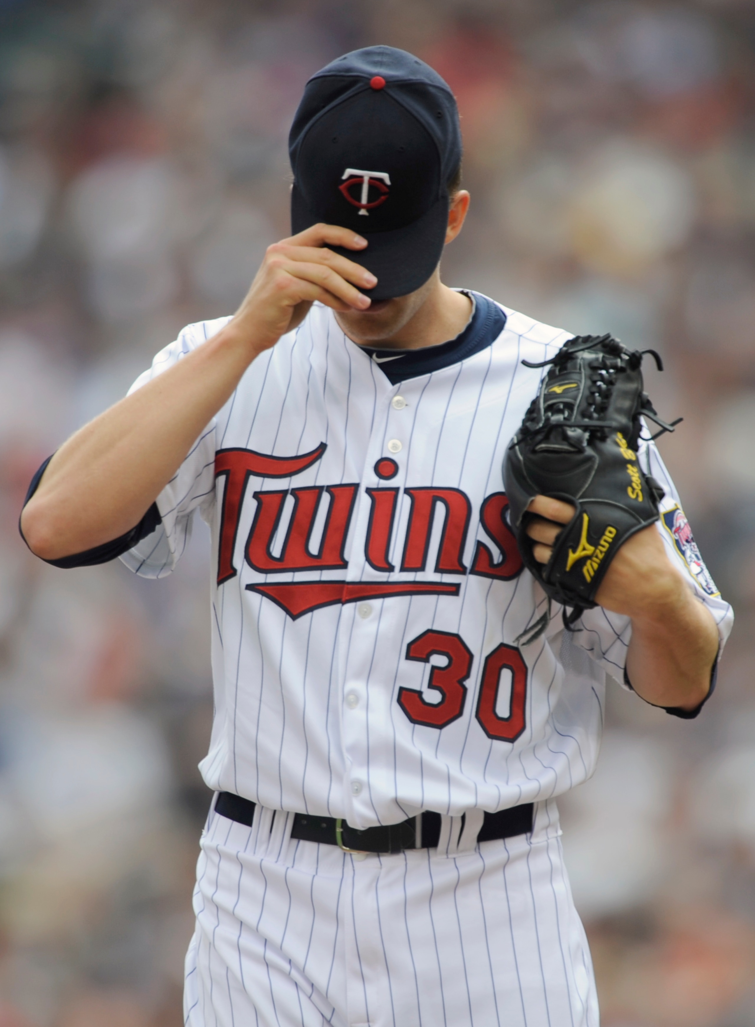 MINNEAPOLIS, MN - APRIL 10: Starting pitcher Scott Baker #30 of the Minnesota Twins adjusts his hat during the first inning of their game against the Minnesota Twins on April 10, 2011 at Target Field in Minneapolis, Minnesota. (Photo by Hannah Foslien/Get MINNEAPOLIS, MN - APRIL 10: Starting pitcher Scott Baker #30 of the Minnesota Twins adjusts his hat during the first inning of their game against the Minnesota Twins on April 10, 2011 at Target Field in Minneapolis, Minnesota. (Photo by Hannah Foslien/Get