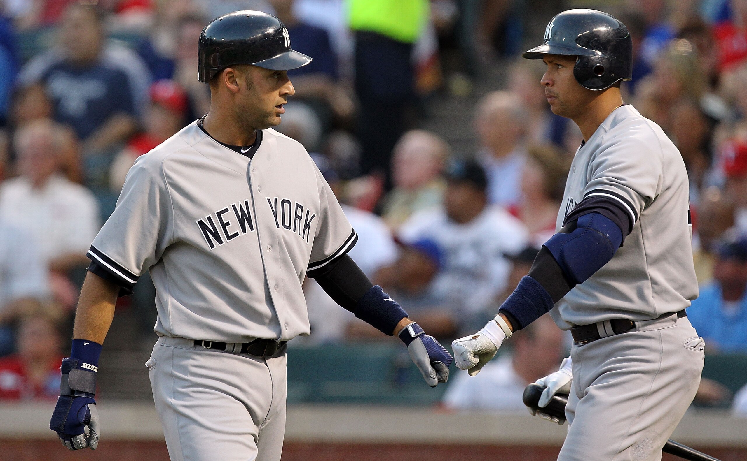 ARLINGTON, TX - MAY 07:  Derek Jeter #2 of the New York Yankees celebrates a run with Alex Rodriguez #13 against the Texas Rangers at Rangers Ballpark in Arlington on May 7, 2011 in Arlington, Texas.  (Photo by Ronald Martinez/Getty Images)