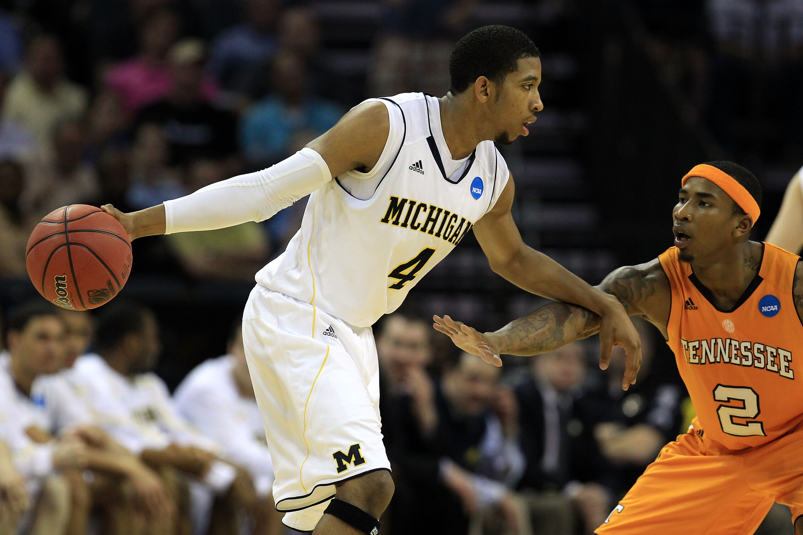 CHARLOTTE, NC - MARCH 18:  Darius Morris #4 of the Michigan Wolverines moves the ball against Melvin Goins #2 of the Tennessee Volunteers in the second half during the second round of the 2011 NCAA men's basketball tournament at Time Warner Cable Arena on