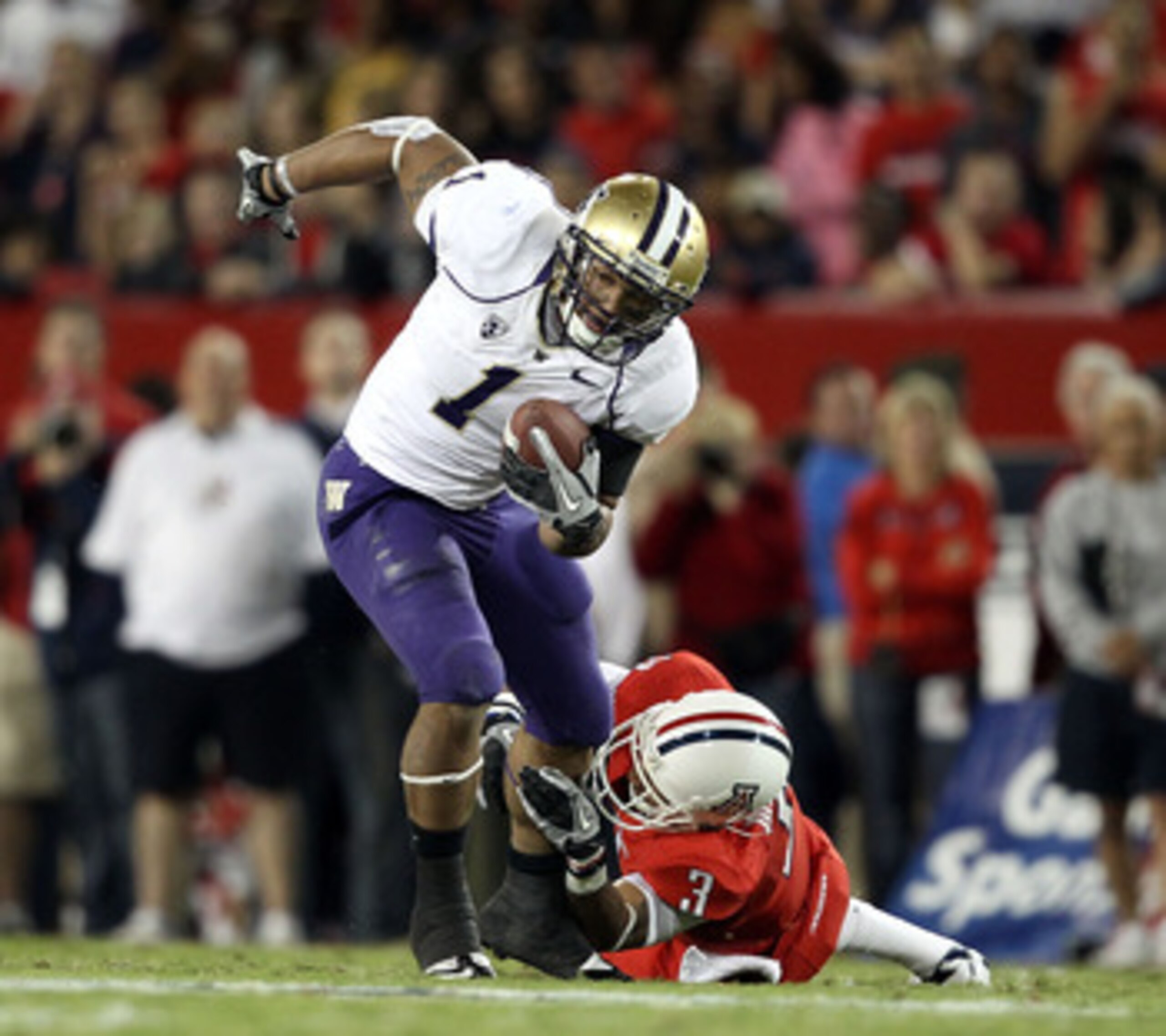 TUCSON, AZ - OCTOBER 23: Runningback Chris Polk #1 of the Washington Huskies rushes the football during the college football game against the Arizona Wildcats at Arizona Stadium on October 23, 2010 in Tucson, Arizona. The Wildcats defeated the Huskies 44 TUCSON, AZ - OCTOBER 23: Runningback Chris Polk #1 of the Washington Huskies rushes the football during the college football game against the Arizona Wildcats at Arizona Stadium on October 23, 2010 in Tucson, Arizona. The Wildcats defeated the Huskies 44