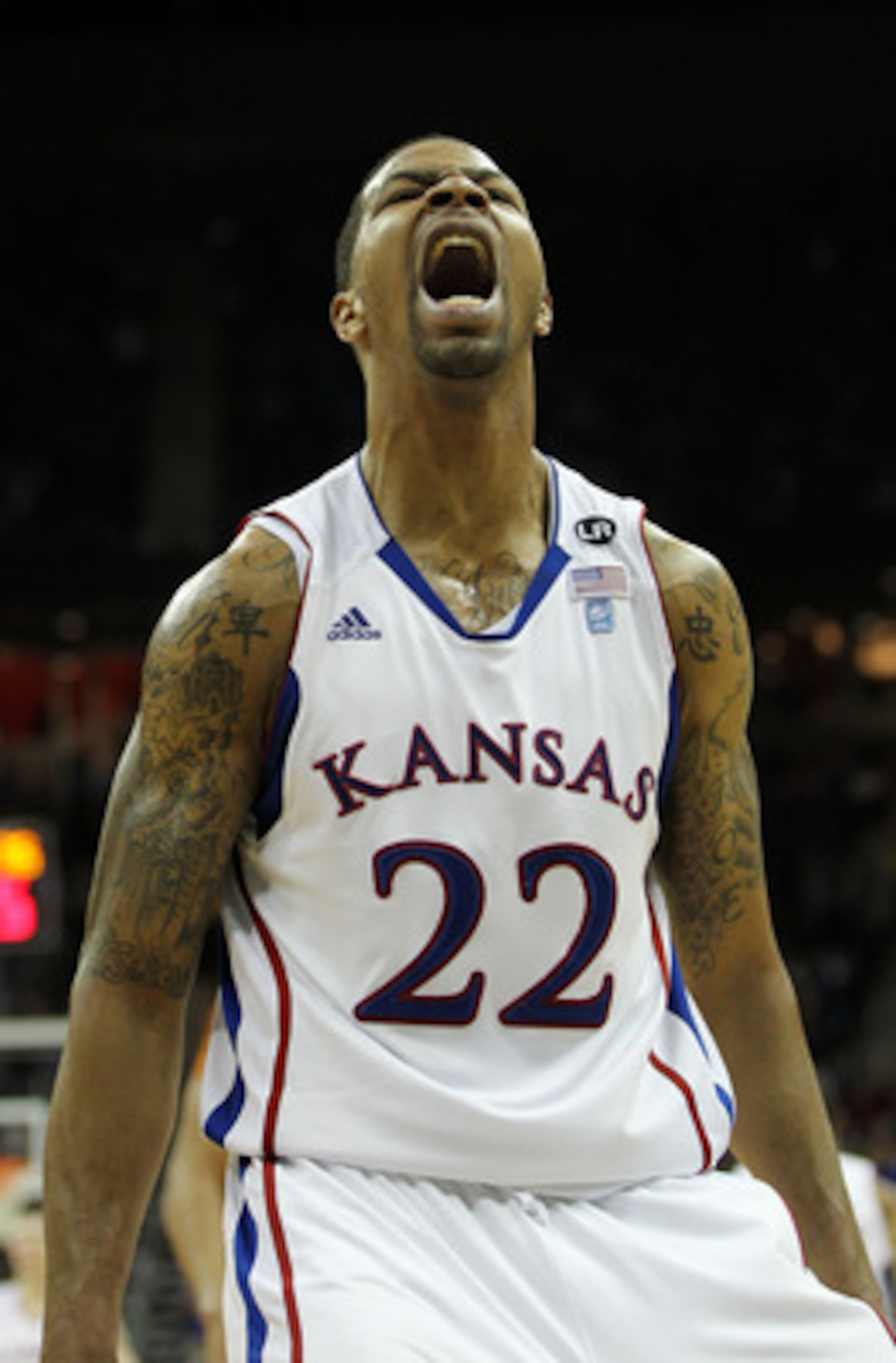 KANSAS CITY, MO - MARCH 12:  Marcus Morris #22 of the Kansas Jayhawks reacts after a dunk against the Texas Longhorns in the second half of the 2011 Phillips 66 Big 12 Men's Basketball Tournament championship game against the Kansas Jayhawks at Sprint Cen
