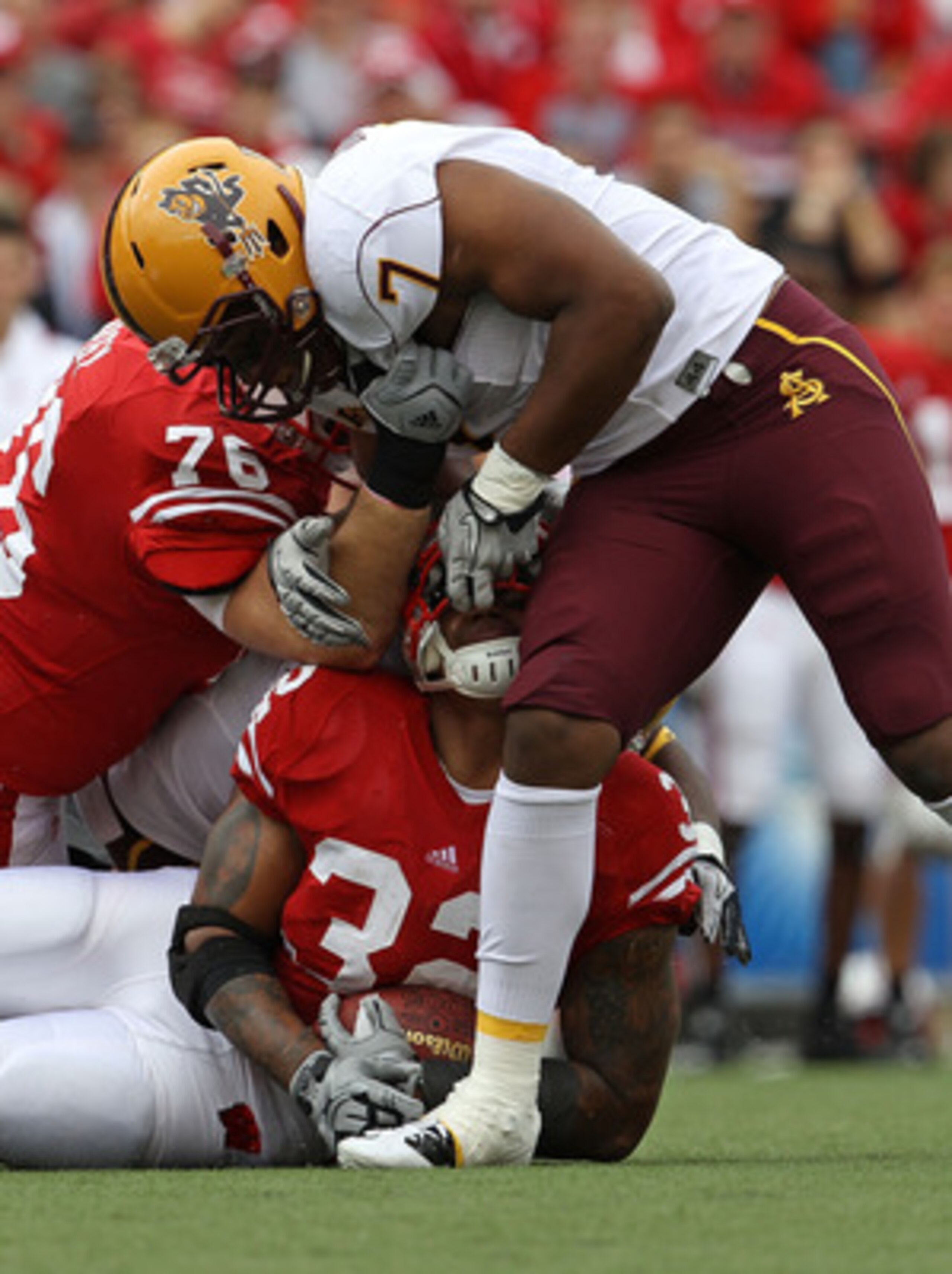 MADISON, WI - SEPTEMBER 18: John Clay #32 of the Wisconsin Badgers is tackled by the fask mask by Vontaze Burfict #7 of the Arizona State Sun Devils at Camp Randall Stadium on September 18, 2010 in Madison, Wisconsin. (Photo by Jonathan Daniel/Getty Image MADISON, WI - SEPTEMBER 18: John Clay #32 of the Wisconsin Badgers is tackled by the fask mask by Vontaze Burfict #7 of the Arizona State Sun Devils at Camp Randall Stadium on September 18, 2010 in Madison, Wisconsin. (Photo by Jonathan Daniel/Getty Image