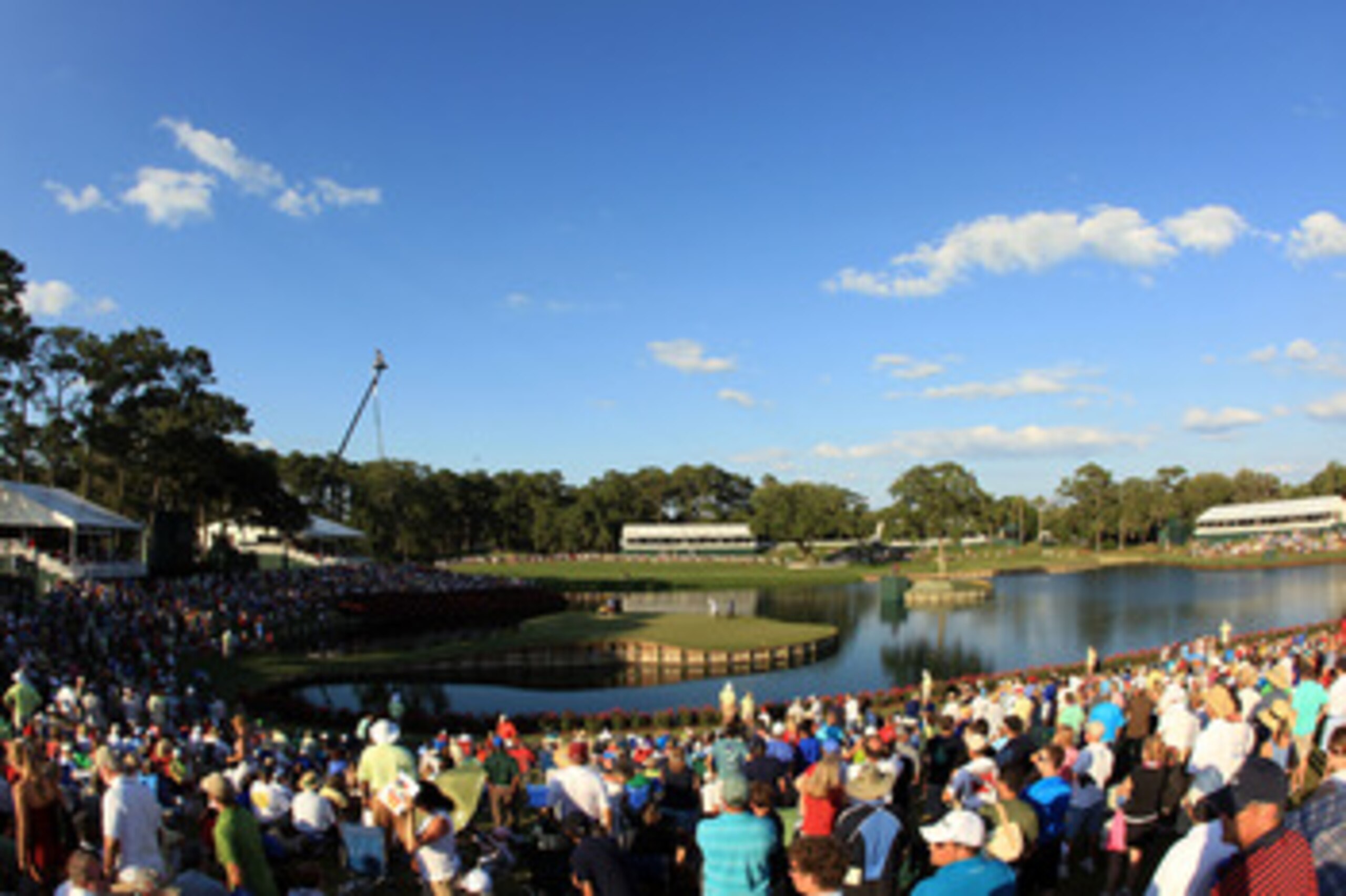 PONTE VEDRA BEACH, FL - MAY 15:  K.J. Choi of South Korea, Graeme McDowell of Northern Ireland of David Toms play the 17th green as fans look on during the final round of THE PLAYERS Championship held at THE PLAYERS Stadium course at TPC Sawgrass on May 1