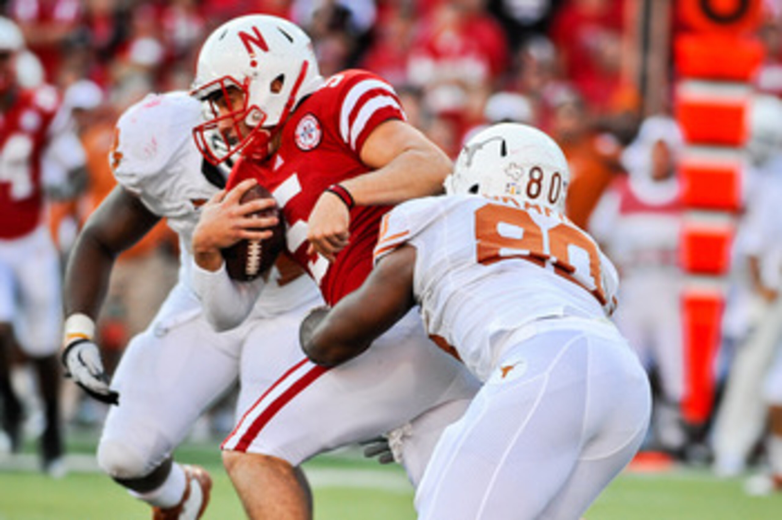LINCOLN, NE - OCTOBER 16: Quarterback Zac Lee #5 of the Nebraska Cornhuskers gets tackled by defensive end Alex Okafor #80 of the Texas Longhorns during their game at Memorial Stadium on October 16, 2010 in Lincoln, Nebraska. Texas Defeated Nebraska 20-13