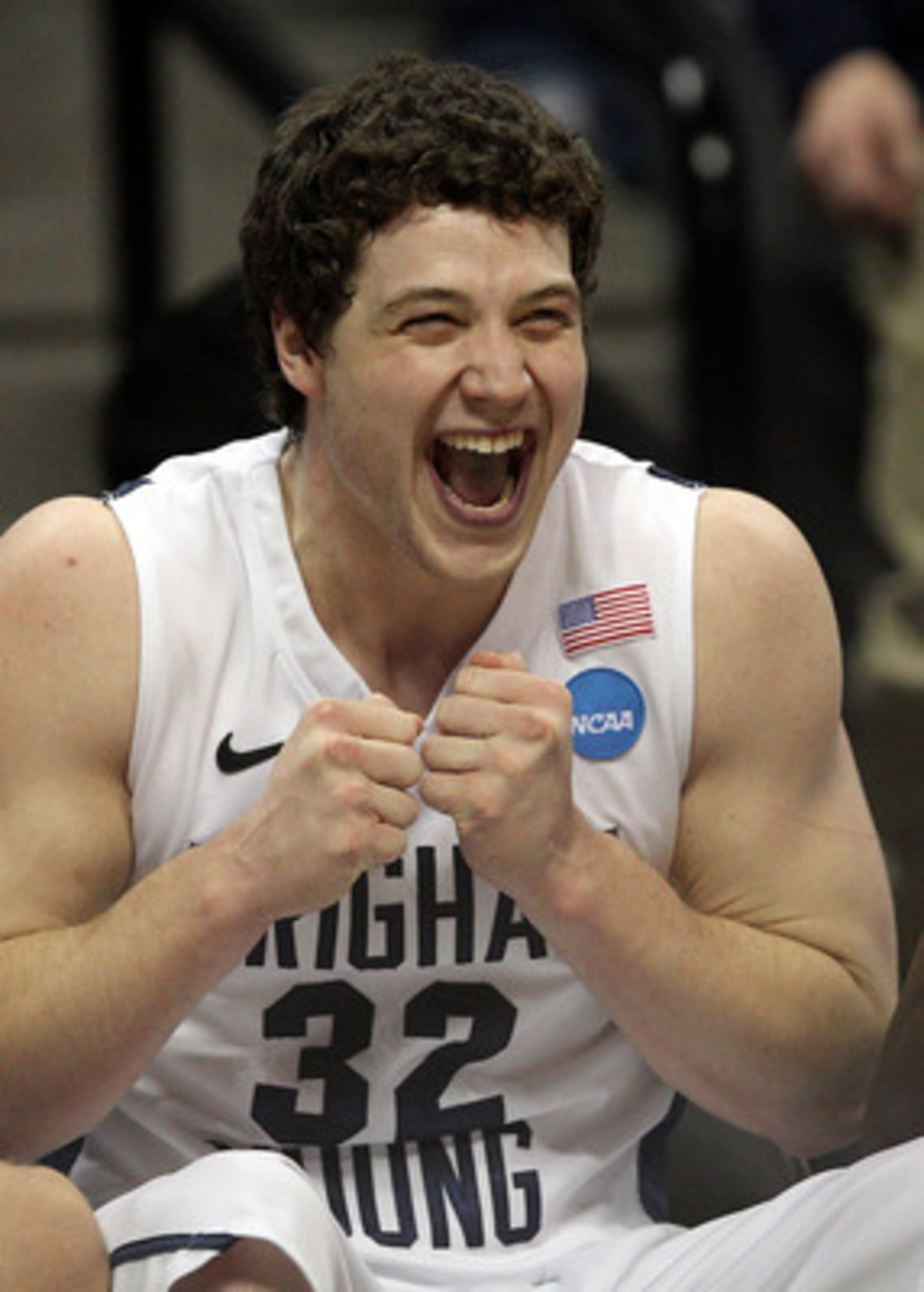 DENVER, CO - MARCH 19:  Jimmer Fredette #32 of the Brigham Young Cougars celebrates on the bench towards the end of the game against the Gonzaga Bulldogs during the third round of the 2011 NCAA men's basketball tournament at Pepsi Center on March 19, 2011