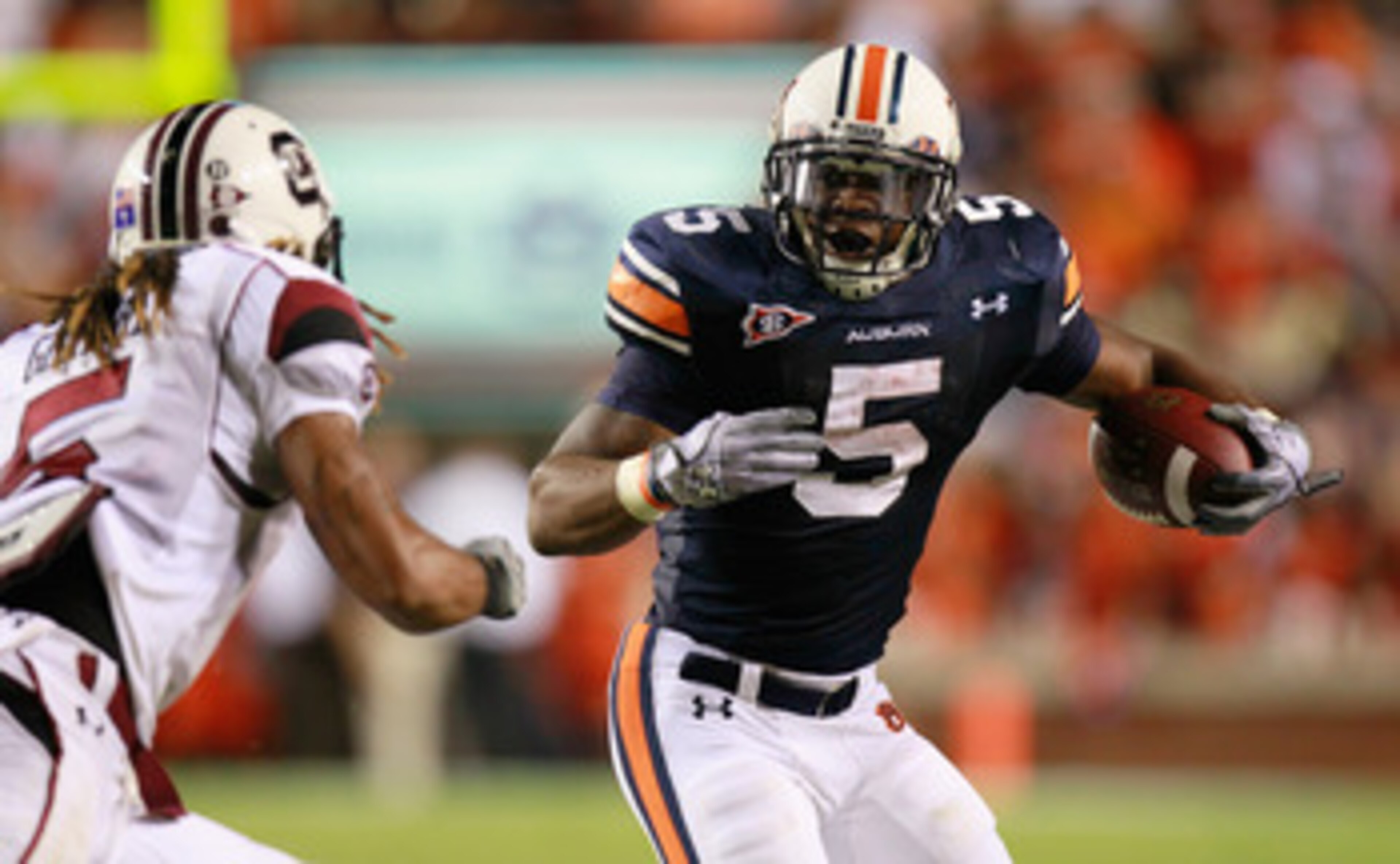 AUBURN, AL - SEPTEMBER 25: Michael Dyer #5 of the Auburn Tigers rushes upfield toward Stephon Gilmore #5 of the South Carolina Gamecocks at Jordan-Hare Stadium on September 25, 2010 in Auburn, Alabama. (Photo by Kevin C. Cox/Getty Images) AUBURN, AL - SEPTEMBER 25: Michael Dyer #5 of the Auburn Tigers rushes upfield toward Stephon Gilmore #5 of the South Carolina Gamecocks at Jordan-Hare Stadium on September 25, 2010 in Auburn, Alabama. (Photo by Kevin C. Cox/Getty Images)