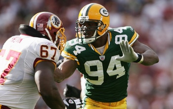 LANDOVER, MD - OCTOBER 31:  Kabeer Gbaja-Biamila #94 of the Green Bay Packers pursues the play against Ray Brown #67 of the Washington Redskins at FedEx Field on October 31, 2004 in Landover, Maryland. The Packers defeated the Redskins 28-14. (Photo by Do