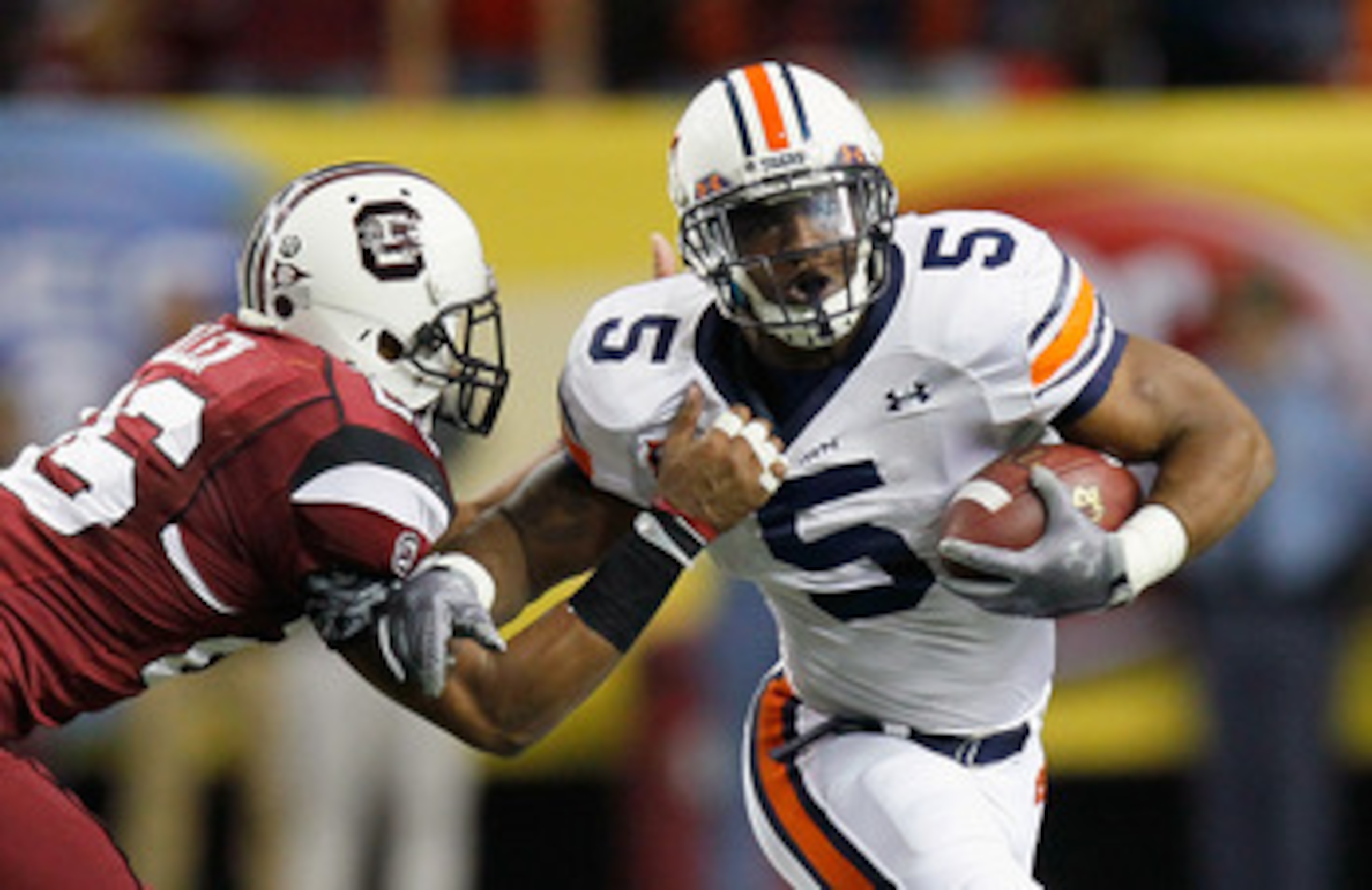 ATLANTA, GA - DECEMBER 04:  Michael Dyer #5 of the Auburn Tigers is tackled by Antonio Allen #26 of the South Carolina Gamecocks during the 2010 SEC Championship at Georgia Dome on December 4, 2010 in Atlanta, Georgia.  (Photo by Kevin C. Cox/Getty Images