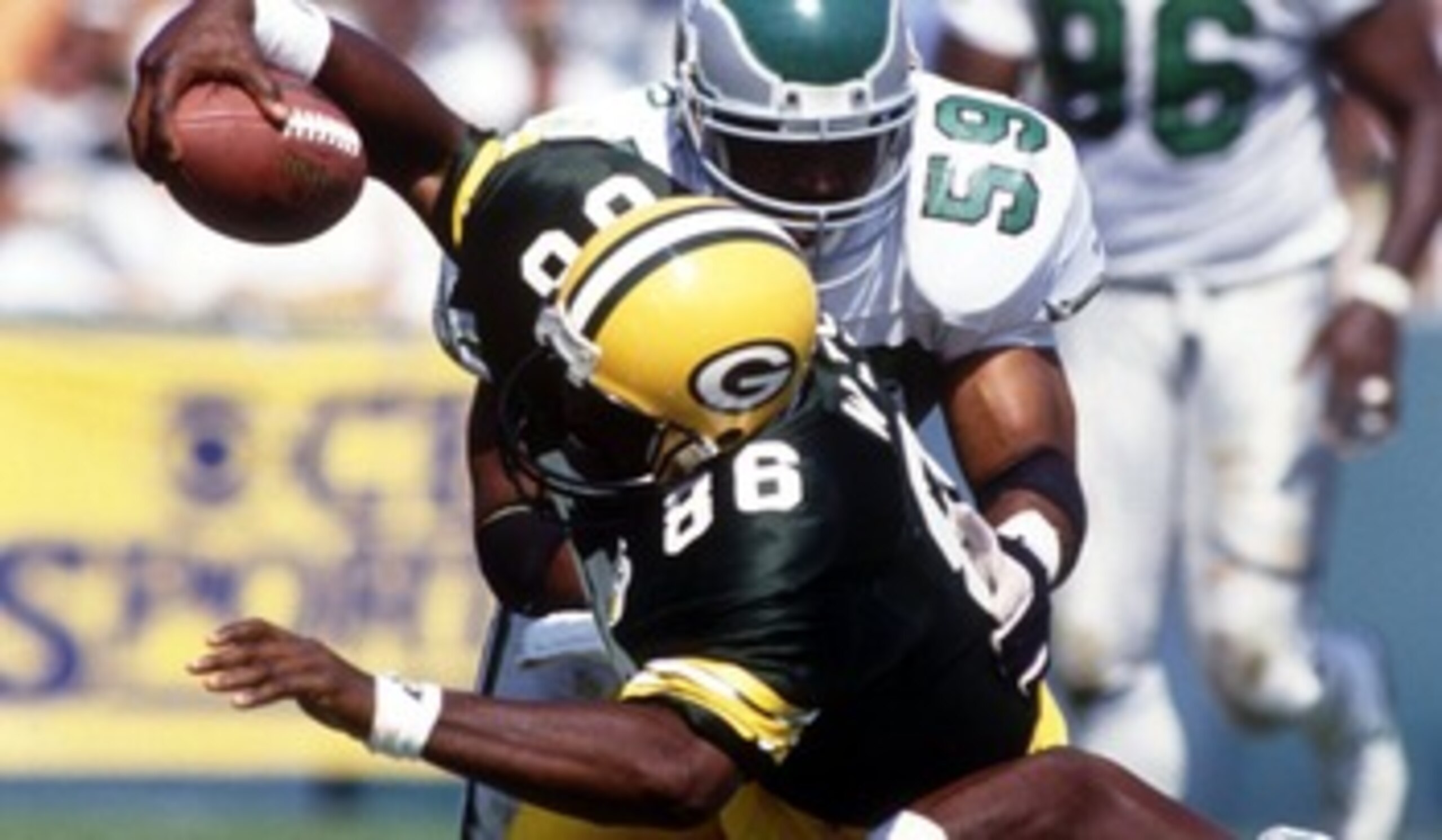 Seth Joyner (Philadelphia Eagles) is stopped by the combined efforts of Ed West (86) and William Frizzell, during the Eagles 20-17 win over the Green Bay Packers. Mandatory Credit: Jonathan Daniel/ALLSPORT