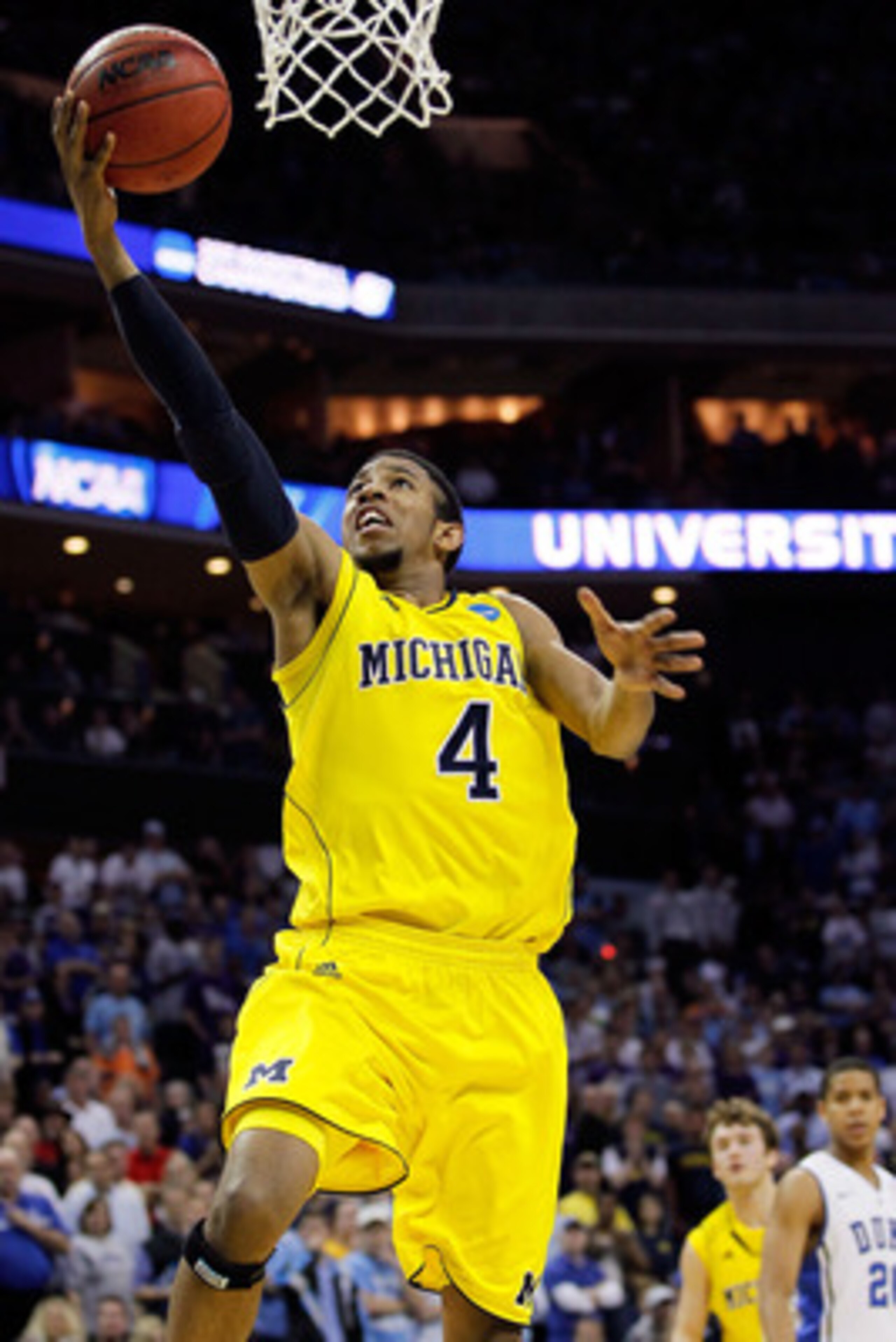 CHARLOTTE, NC - MARCH 20:  Darius Morris #4 of the Michigan Wolverines lays the ball up while taking on the Duke Blue Devils during the third round of the 2011 NCAA men's basketball tournament at Time Warner Cable Arena on March 20, 2011 in Charlotte, Nor