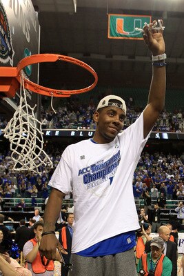 GREENSBORO, NC - MARCH 13:  Kyrie Irving #1 of the Duke Blue Devils cuts down the net after defeating the North Carolina Tar Heels 75-58 in the championship game of the 2011 ACC men's basketball tournament at the Greensboro Coliseum on March 13, 2011 in G