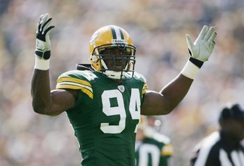 GREEN BAY, WI - OCTOBER 8:  Defensive end Kabeer Gbaja-Biamila #94 of the Green Bay Packers raises his arms during the game against the St. Louis Rams at Lambeau Field on October 8, 2006 in Green Bay, Wisconsin. The Rams defeated the Packers 23-20.  (Phot