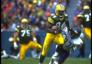 31 OCT 1993:  GREEN BAY PACKERS WIDE RECEIVER STERLING SHARPE GIVES A STRAIGHT ARM TO AN UNIDENTIFIED CHICAGO BEARS DEFENSEMAN DURING THE PACKERS 17-3 WIN AT LAMBEAU FIELD IN CHICAGO, ILLINOIS.  MANDATORY CREDIT:  JONATHAN DANIEL/ALLSPORT