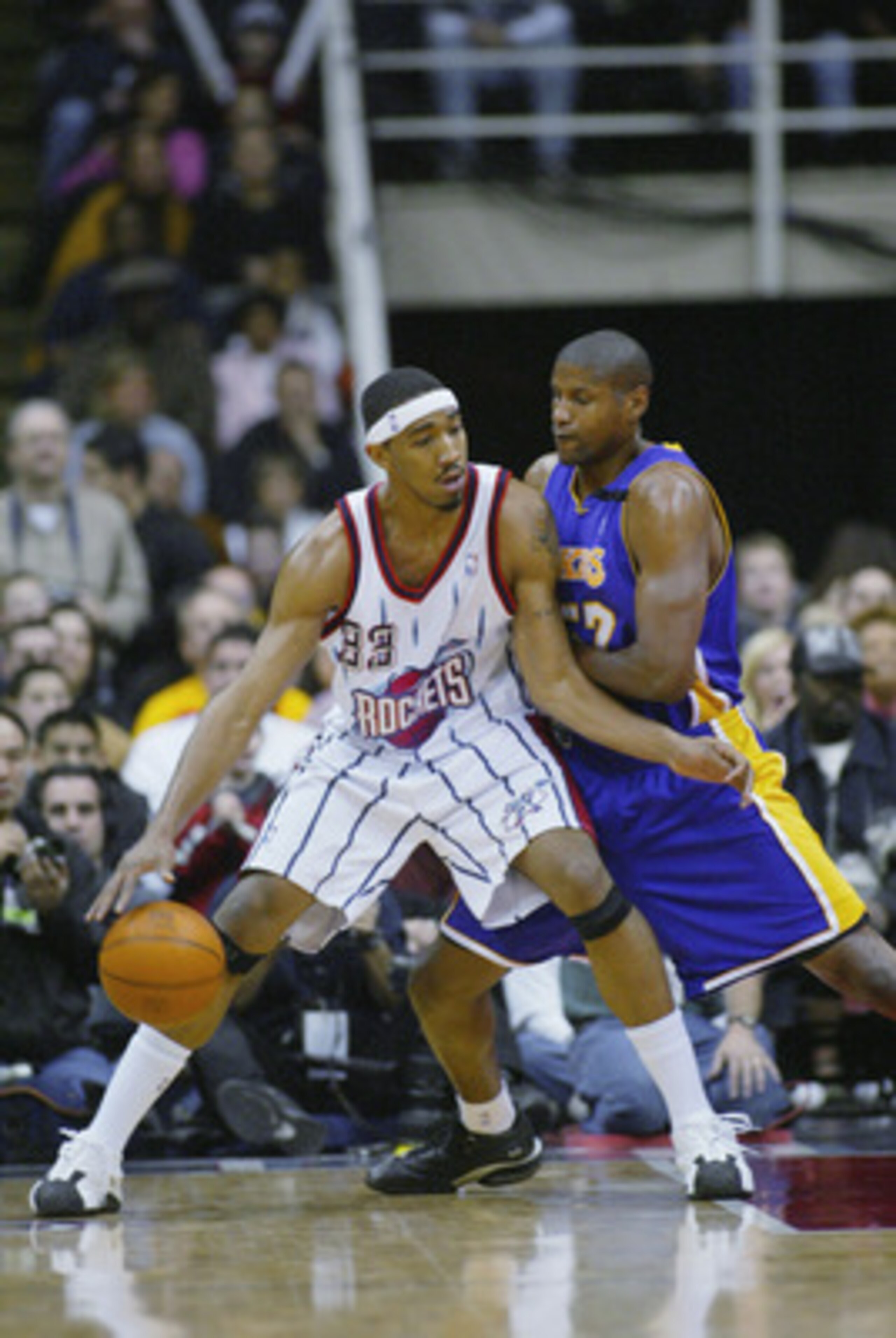 HOUSTON - JANUARY 17:  Eddie Griffin #33 of the Houston Rockets is defended by Samake Walker #52 of the Los Angeles Lakers during the game at Compaq Center on January 17, 2003 in Houston, Texas.  The Rockets won in overtime 108-104.  NOTE TO USER: User ex