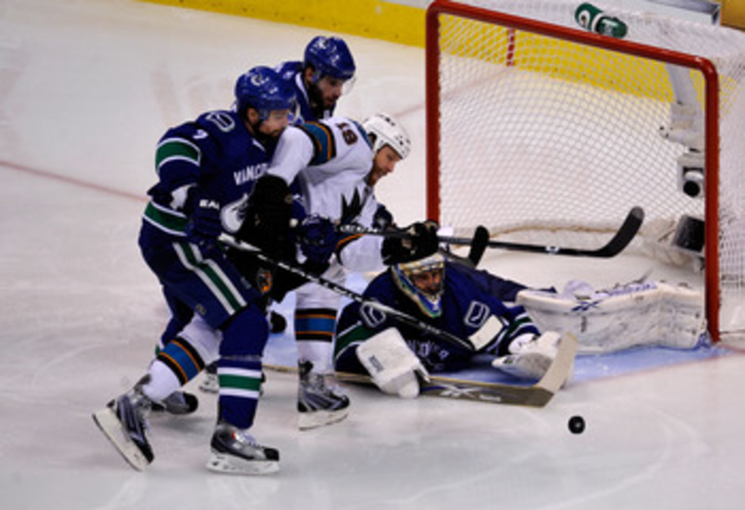 VANCOUVER, CANADA - MAY 15: Ryan Kesler #17 and Dan Hamhuis #2 of the Vancouver Canucks defend Joe Thornton #19 of the San Jose Sharks goaltender Roberto Luongo #1 makes a save in the third period in the second period in Game One of the Western Conferenc VANCOUVER, CANADA - MAY 15: Ryan Kesler #17 and Dan Hamhuis #2 of the Vancouver Canucks defend Joe Thornton #19 of the San Jose Sharks goaltender Roberto Luongo #1 makes a save in the third period in the second period in Game One of the Western Conferenc