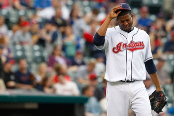 CLEVELAND - MAY 13:  Fausto Carmona #55 of the Cleveland Indians takes a moment to himself before pitching against the Seattle Mariners during the game on May 13, 2011 at Progressive Field in Cleveland, Ohio.  (Photo by Jared Wickerham/Getty Images)