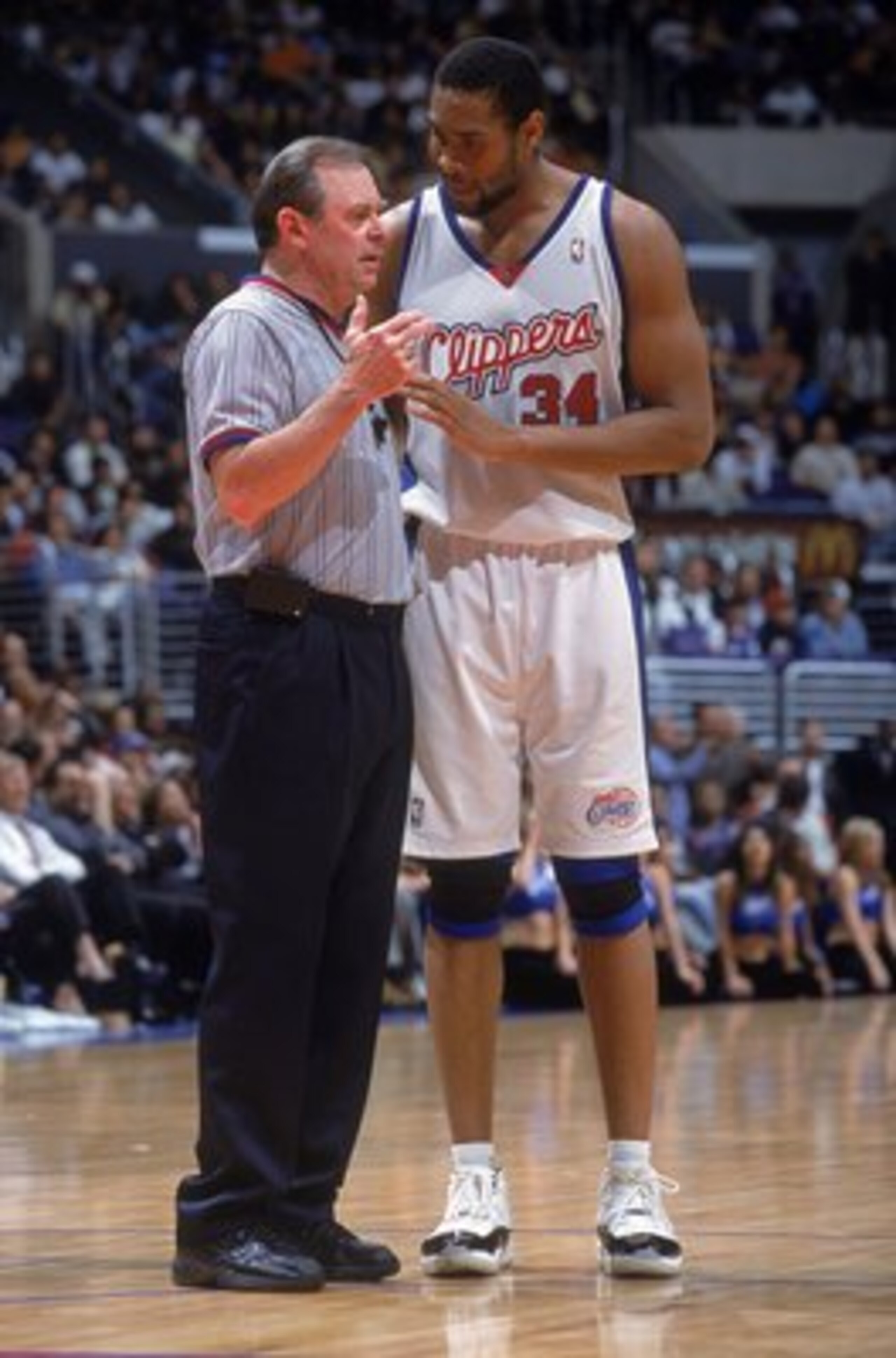 20 Mar 2001:  Michael Olowdokandi #34 of the Los Angeles Clippers talks with a Referee on the court during the game against the Philadelphia 76ers at the STAPLES Center in Los Angeles, California.  The Clippers defeated the 76ers 88-77.    NOTE TO USER: I