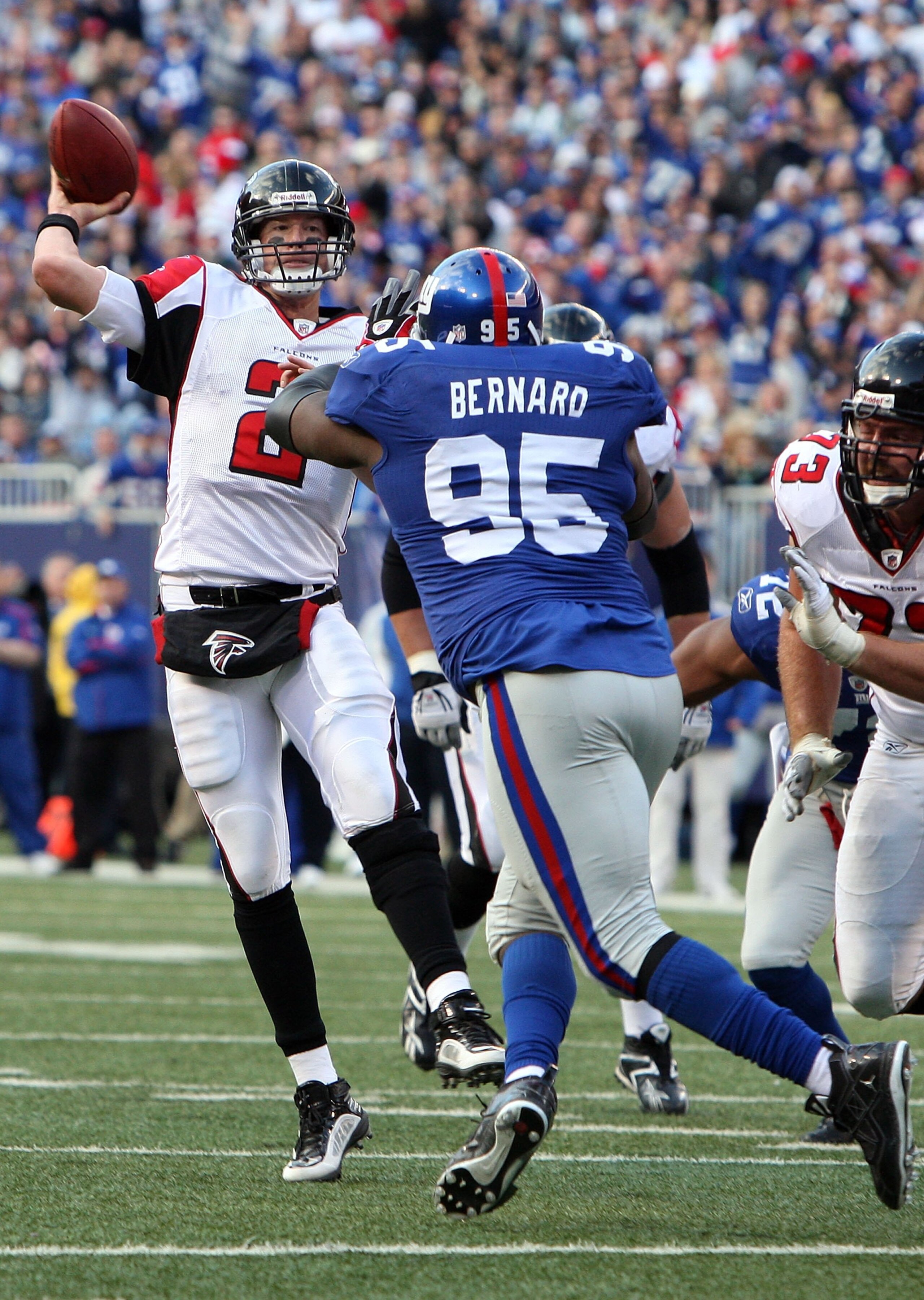 EAST RUTHERFORD, NJ - NOVEMBER 22:  Matt Ryan #2 of the Atlanta Falcons throws a pass under pressure from Rocky Bernard #95 of the New York Giants on November 22, 2009 at Giants Stadium in East Rutherford, New Jersey. The Giants defeated the Falcons 34-31