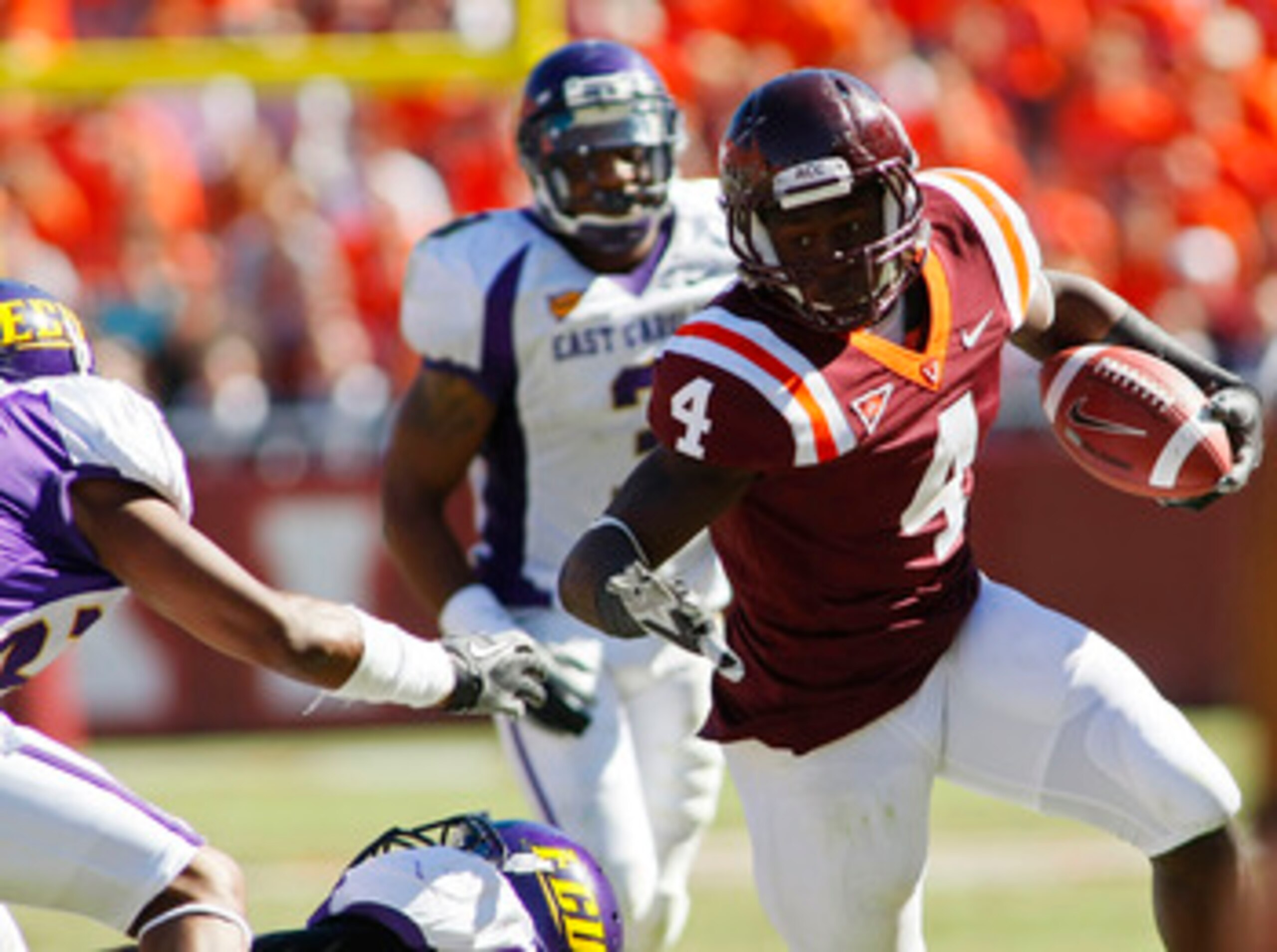 BLACKSBURG, VA - SEPTEMBER 18:  Running back David Wilson #4 of the Virginia Tech Hokies runs with the ball as cornerback Desi Brown #23 of the East Carolina Pirates tries to make the tackle at Lane Stadium on September 18, 2010 in Blacksburg, Virginia.  