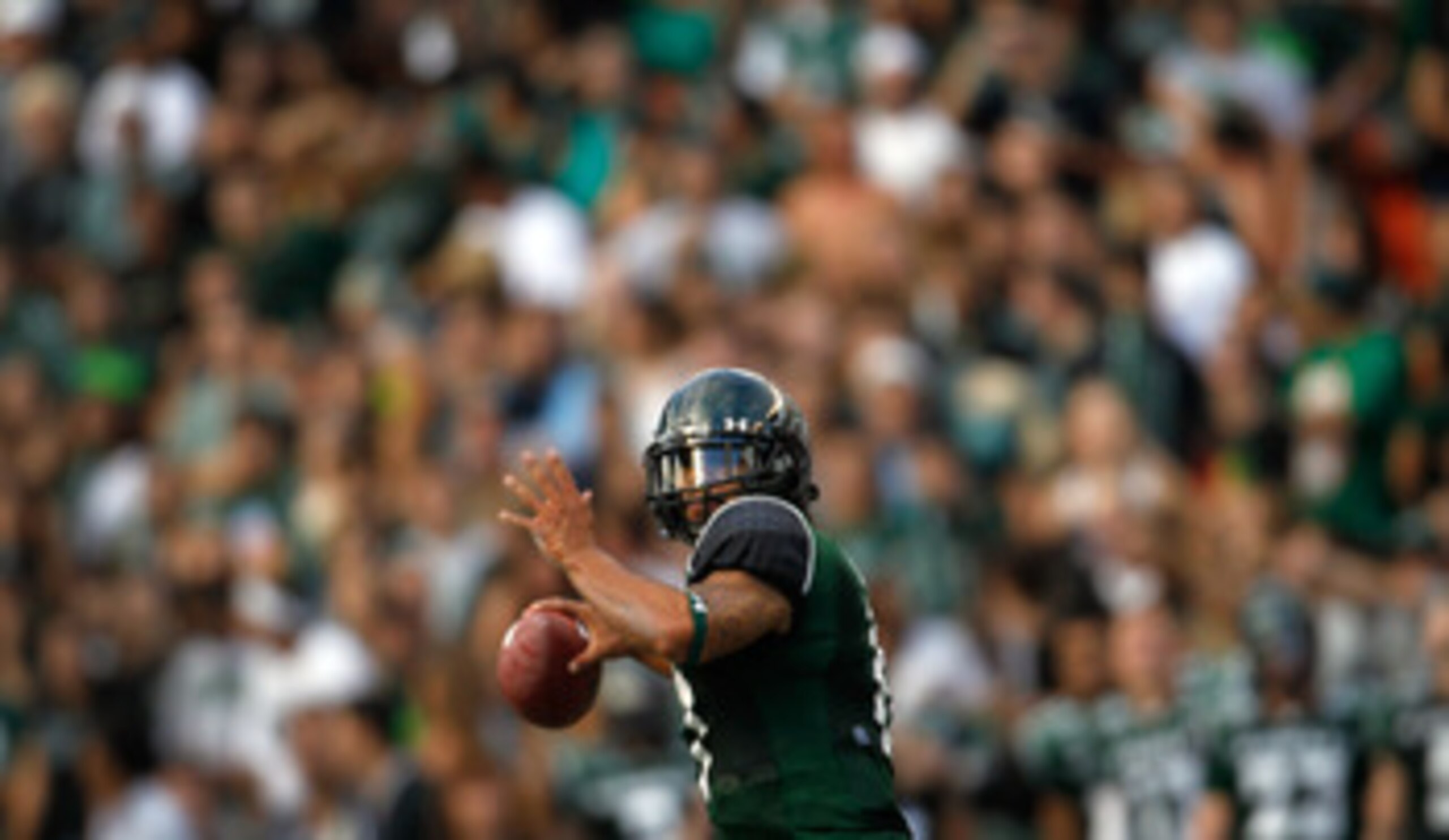HONOLULU - SEPTEMBER 2:  Quarterback Bryant Moniz #17 of the University of Hawaii Warriors makes a pass against the University of Southern California Trojans during first half action at Aloha Stadium September 2, 2010 in Honolulu, Hawaii. (Photo by Kent N
