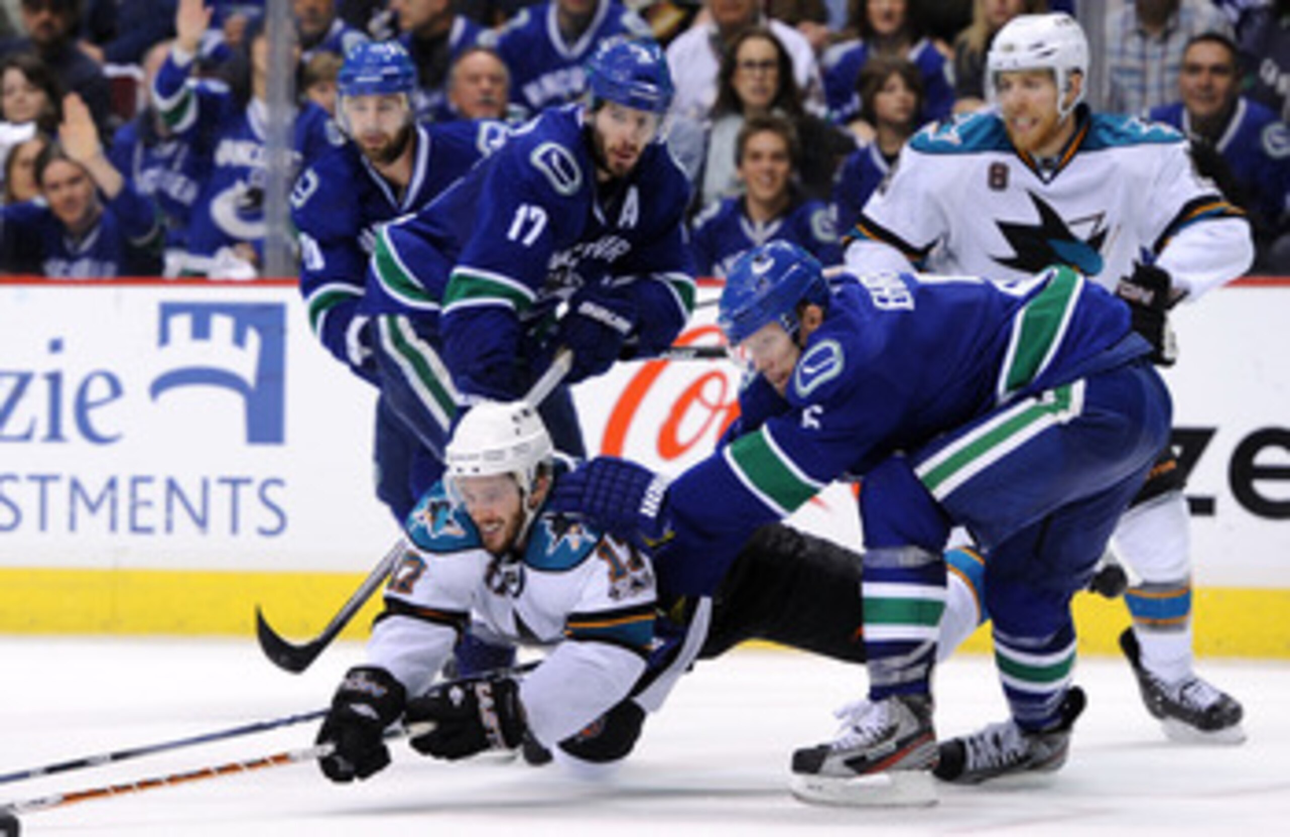 VANCOUVER, CANADA - MAY 15: Torrey Mitchell #17 of the San Jose Sharks dives to poke at the puck as Ryan Kesler #17 and Christian Ehrhoff #5 of the Vancouver Canucks defend the play in Game One of the Western Conference Finals during the 2011 Stanley Cup VANCOUVER, CANADA - MAY 15: Torrey Mitchell #17 of the San Jose Sharks dives to poke at the puck as Ryan Kesler #17 and Christian Ehrhoff #5 of the Vancouver Canucks defend the play in Game One of the Western Conference Finals during the 2011 Stanley Cup