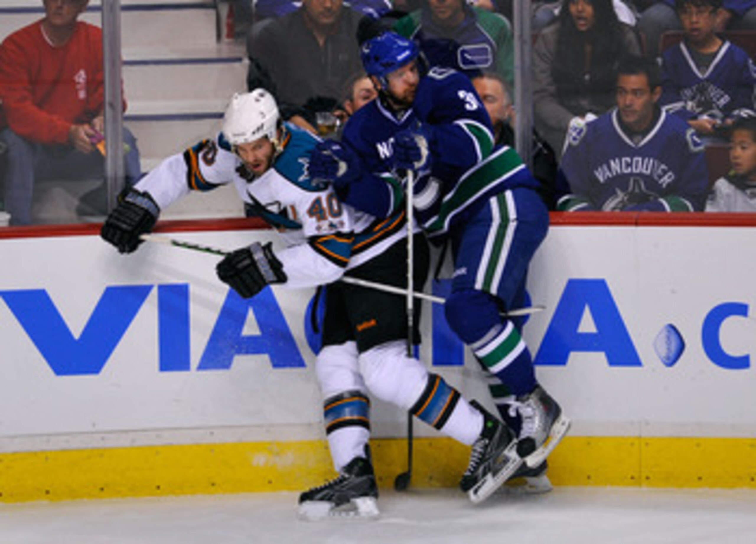 VANCOUVER, CANADA - MAY 15: Jannik Hansen #36 of the Vancouver Canucks checks Kent Huskins #40 of the San Jose Sharks in Game One of the Western Conference Finals during the 2011 Stanley Cup Playoffs at Rogers Arena on May 15, 2011 in Vancouver, British VANCOUVER, CANADA - MAY 15: Jannik Hansen #36 of the Vancouver Canucks checks Kent Huskins #40 of the San Jose Sharks in Game One of the Western Conference Finals during the 2011 Stanley Cup Playoffs at Rogers Arena on May 15, 2011 in Vancouver, British